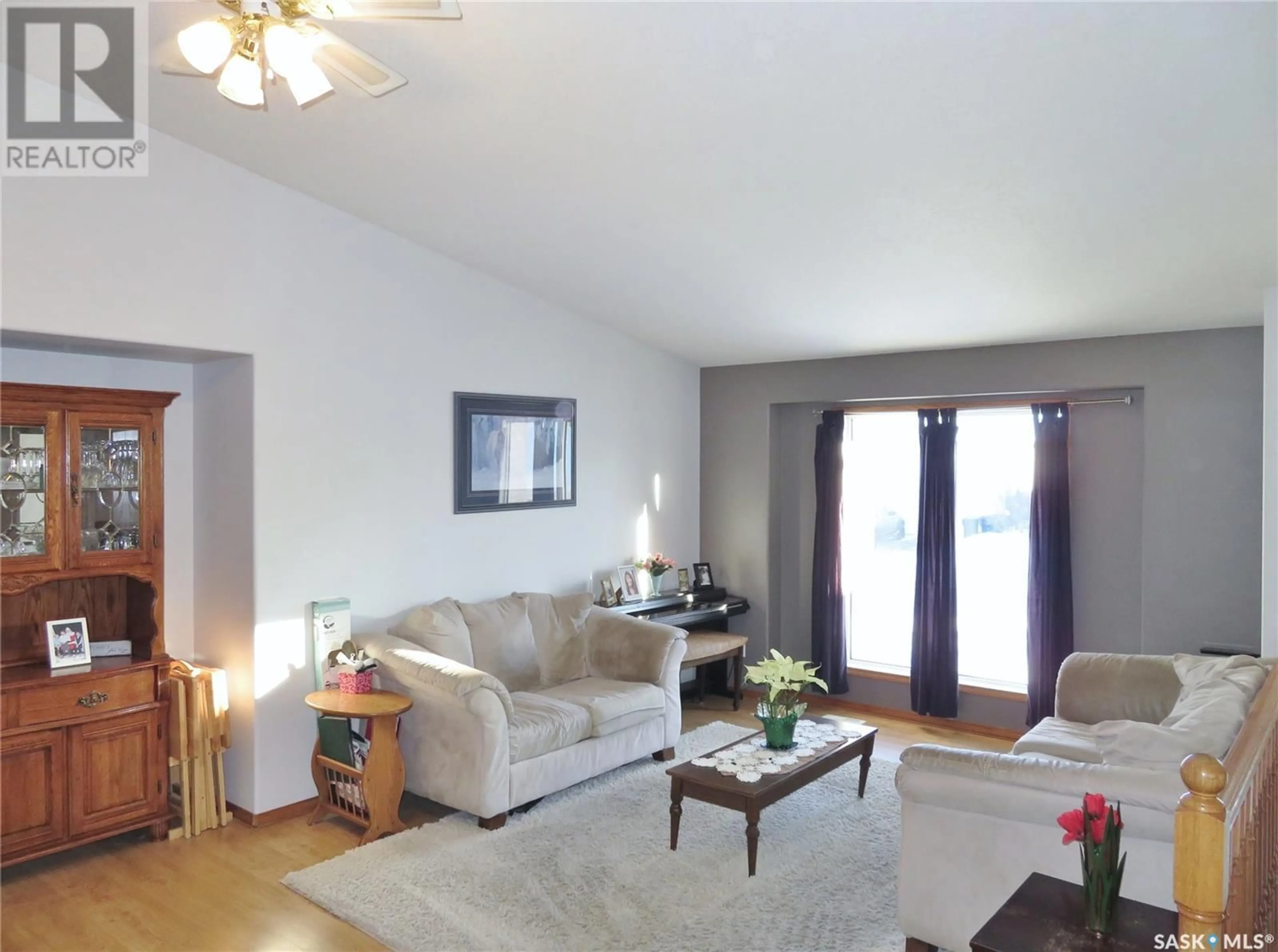 Living room with furniture, wood/laminate floor for 339 Coben CRESCENT, Saskatoon Saskatchewan S7S1B5