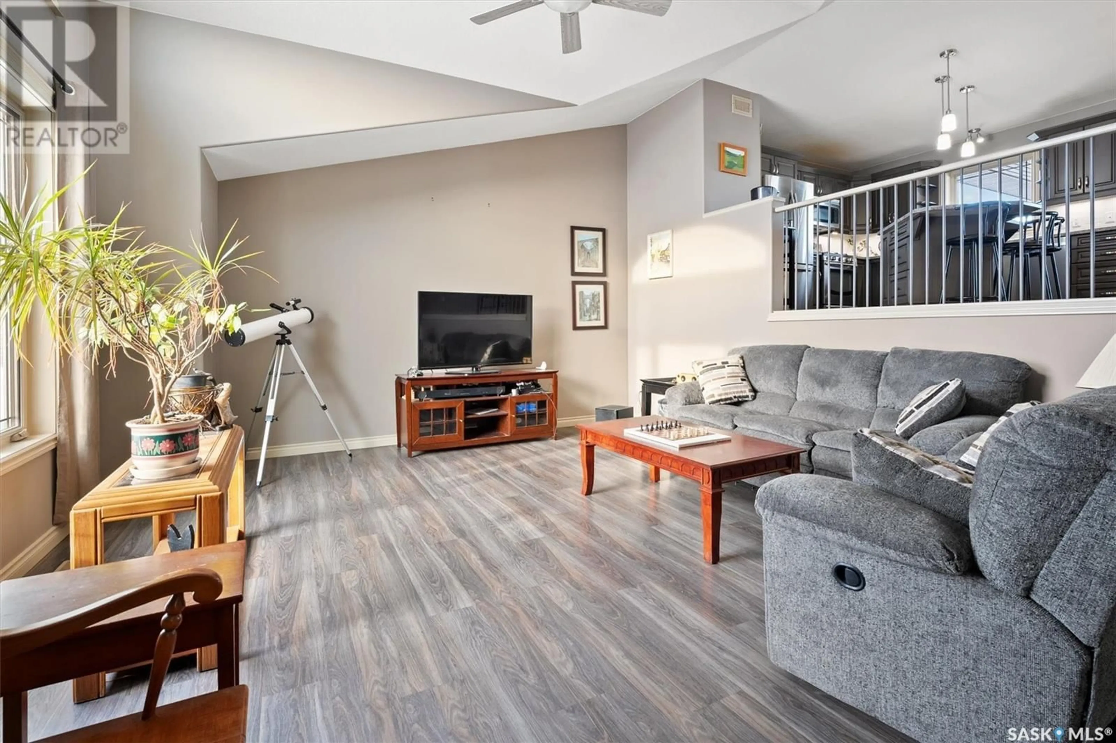 Living room with furniture, wood/laminate floor for 112 Willard DRIVE, Vanscoy Saskatchewan S0L3J0