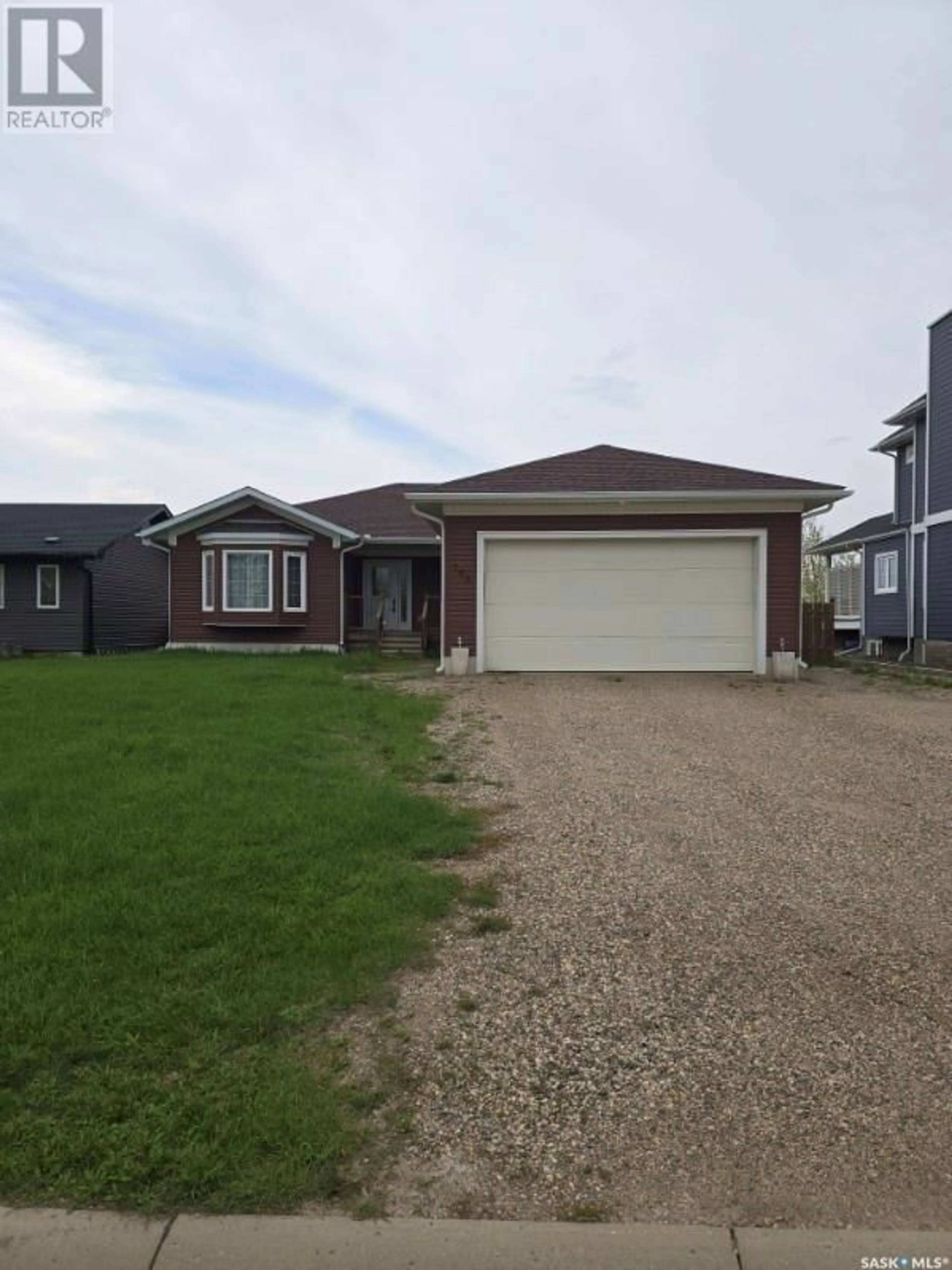 Home with vinyl exterior material, street for 103 Joyce DRIVE, Oxbow Saskatchewan S0C2B0