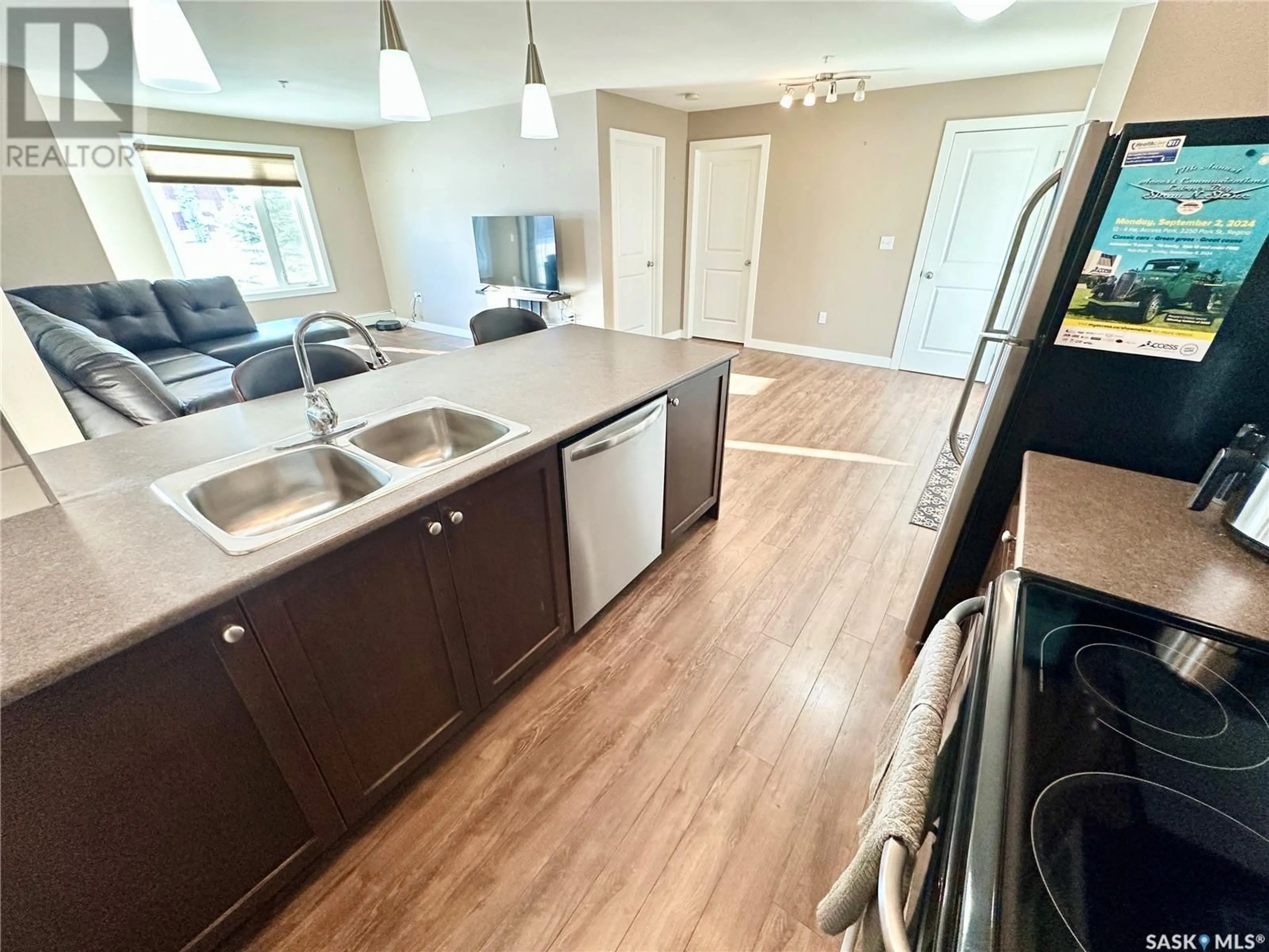 Open concept kitchen, wood/laminate floor for 108 820 5th STREET, Weyburn Saskatchewan S4H2V2