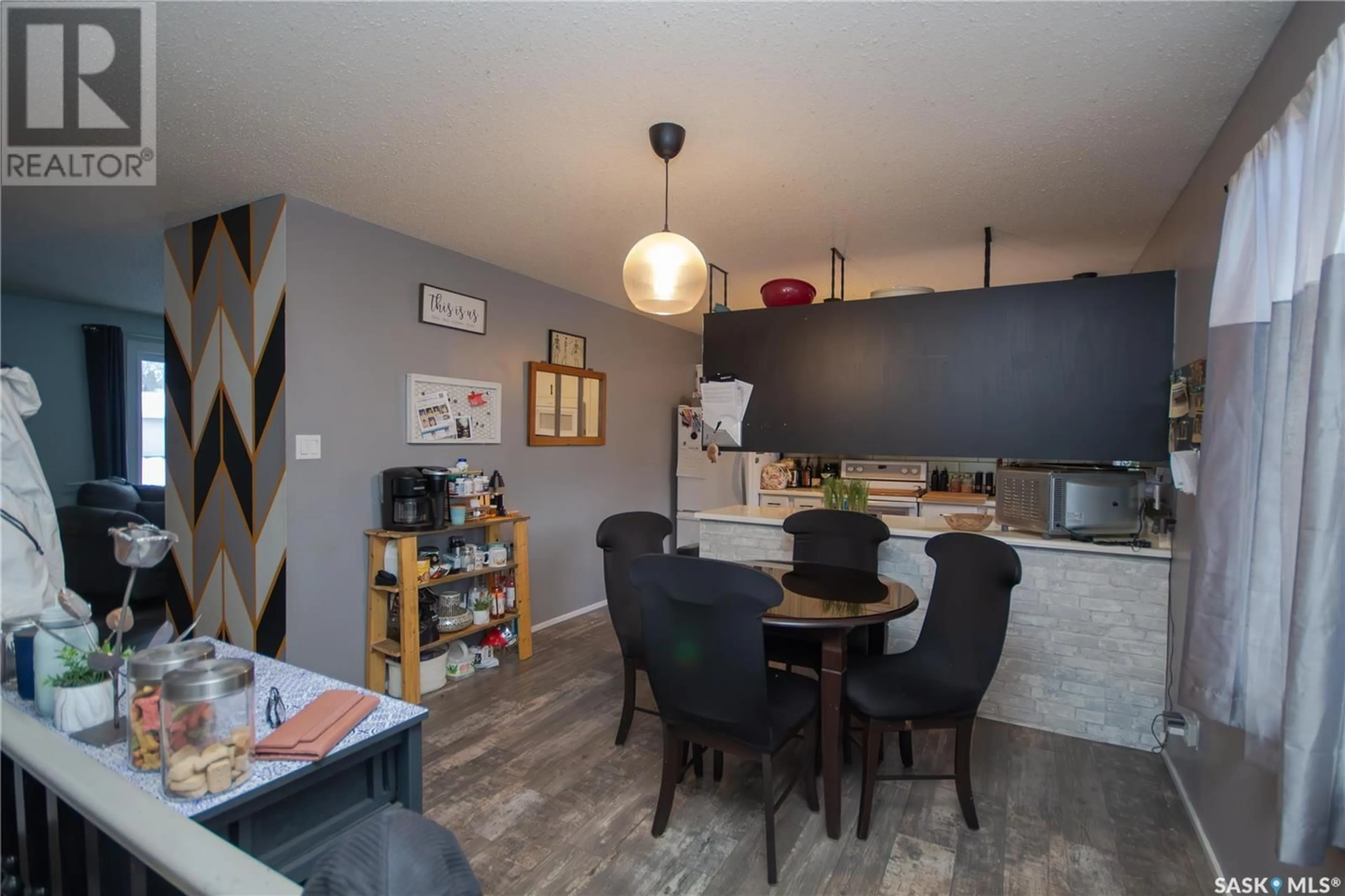 Open concept kitchen, wood/laminate floor for 1381 95th STREET, North Battleford Saskatchewan S9A0G3