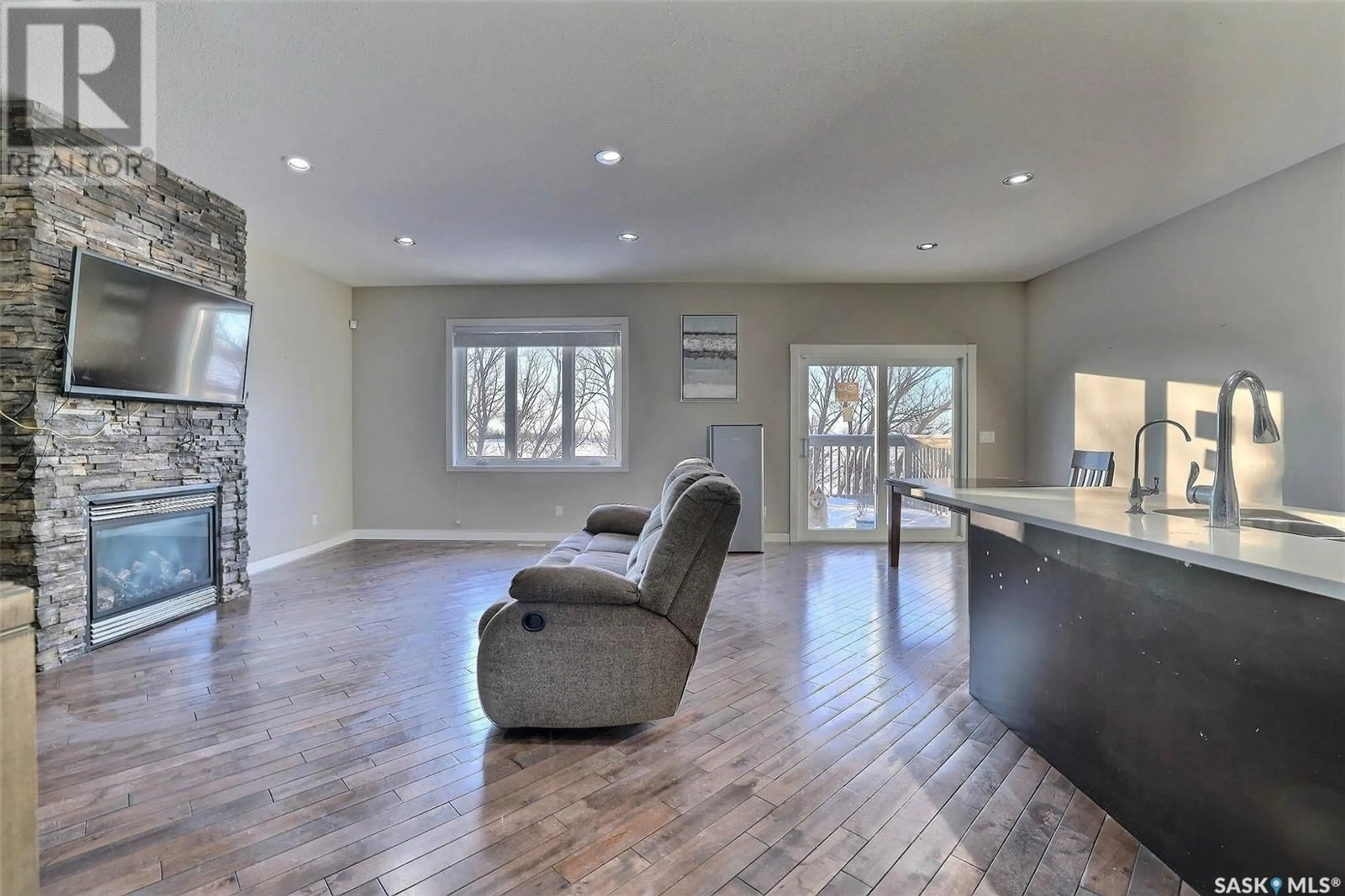 Living room with furniture, wood/laminate floor for 17 Stardust BAY, White City Saskatchewan S4L0A1