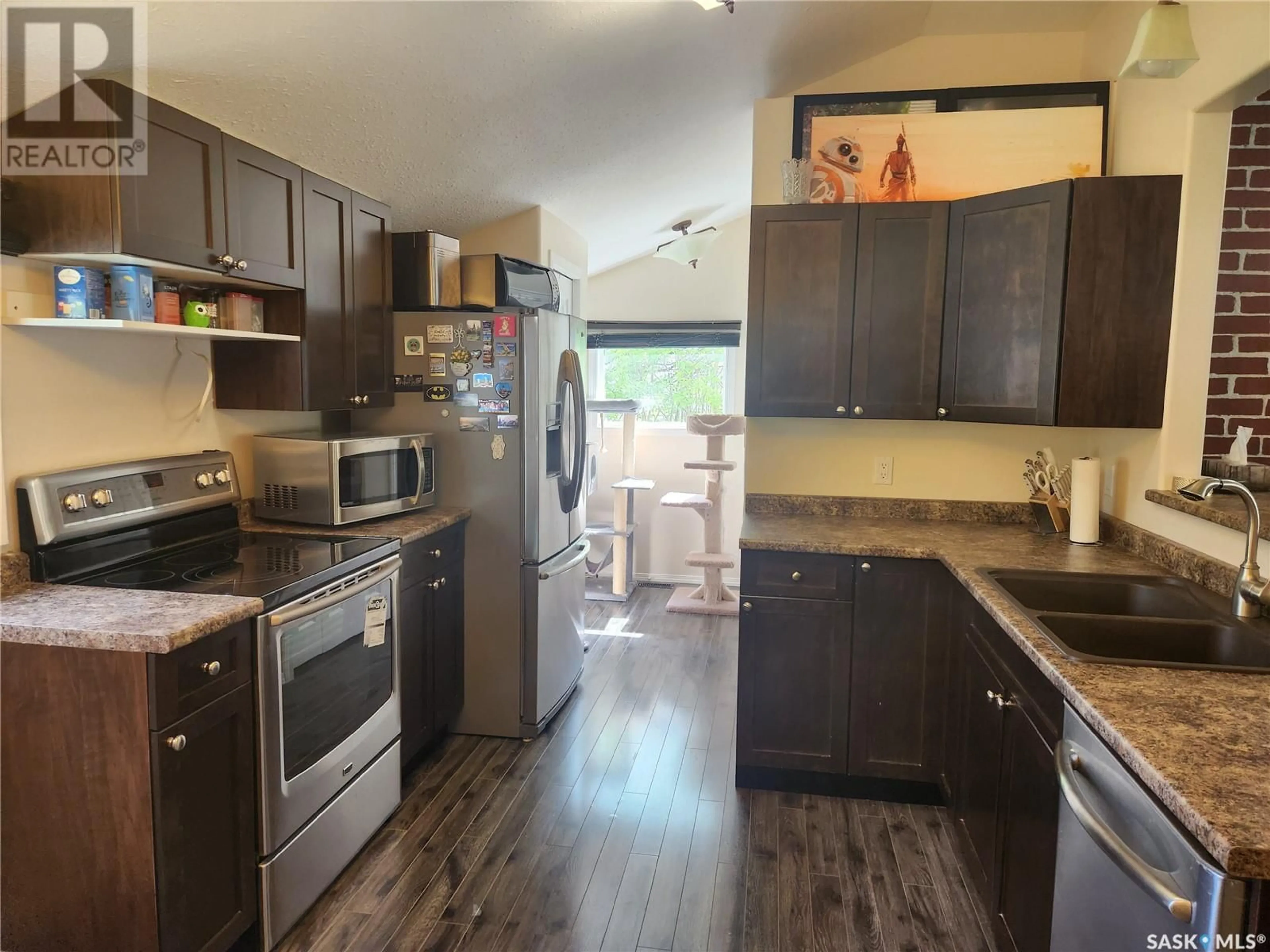 Open concept kitchen, wood/laminate floor for 1005 108th AVENUE, Tisdale Saskatchewan S0E1T0