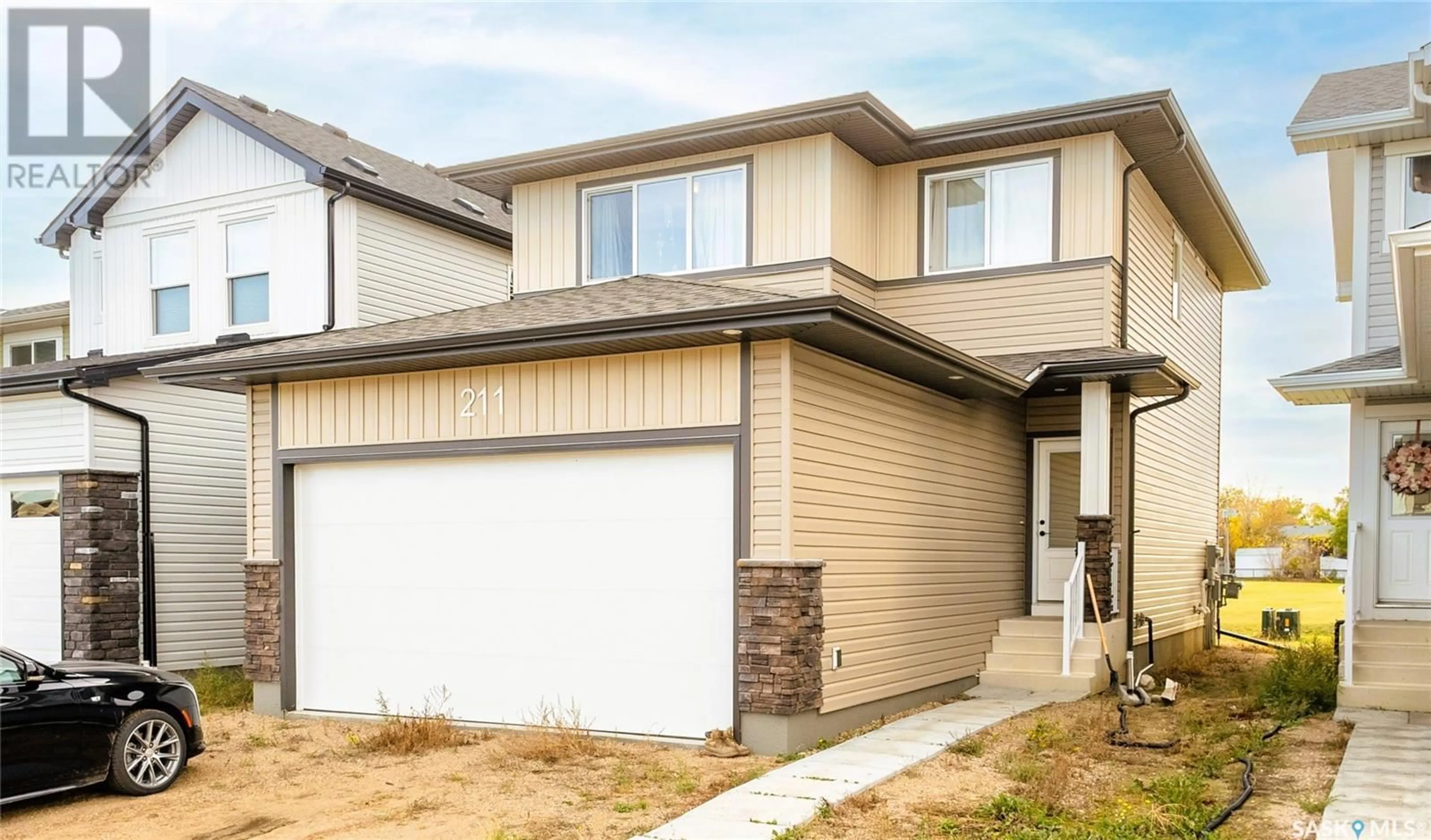 Home with vinyl exterior material, street for 211 Wall STREET, Dalmeny Saskatchewan S0K1E0