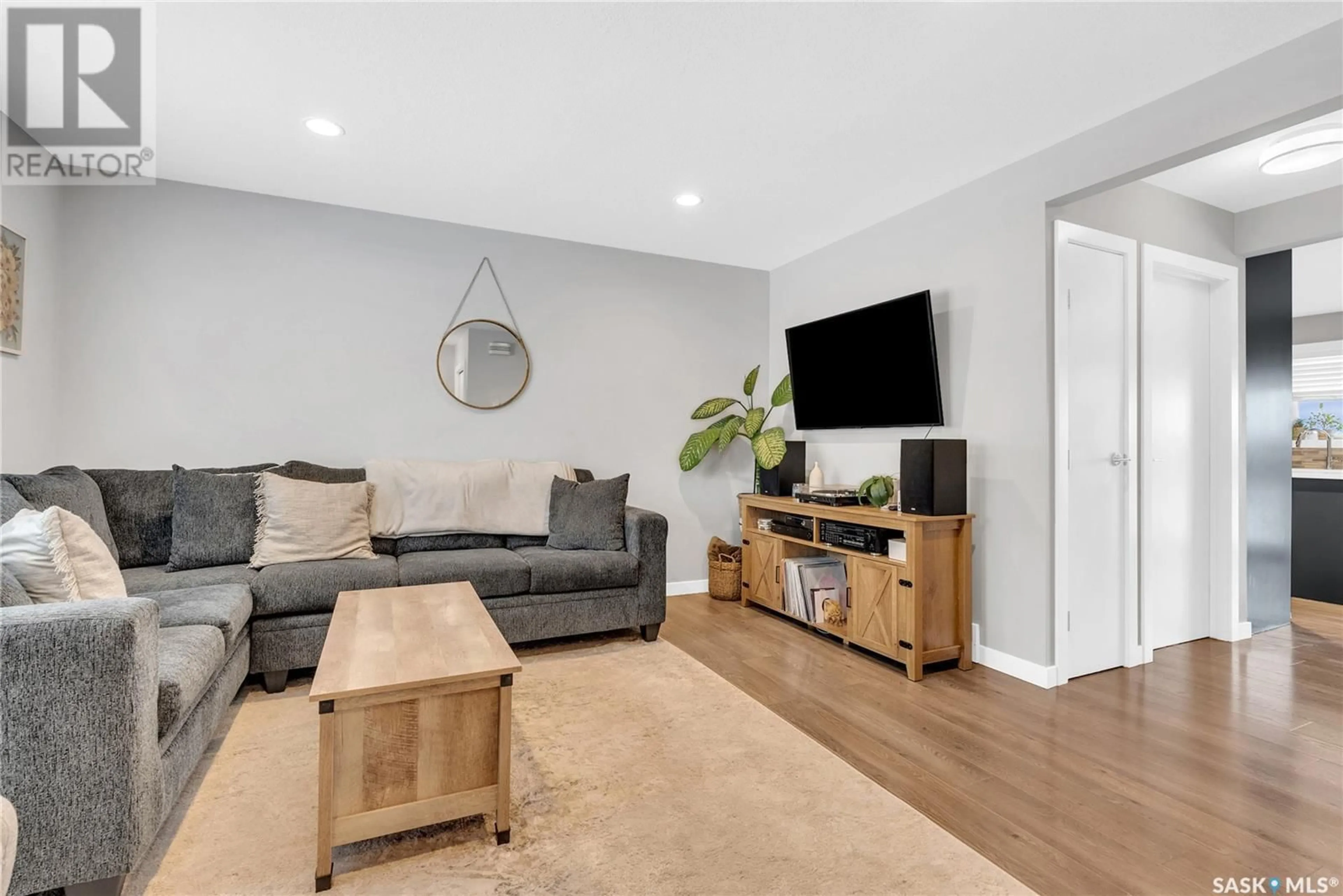 Living room with furniture, wood/laminate floor for 3141 3115 McClocklin ROAD, Saskatoon Saskatchewan S7T0J1