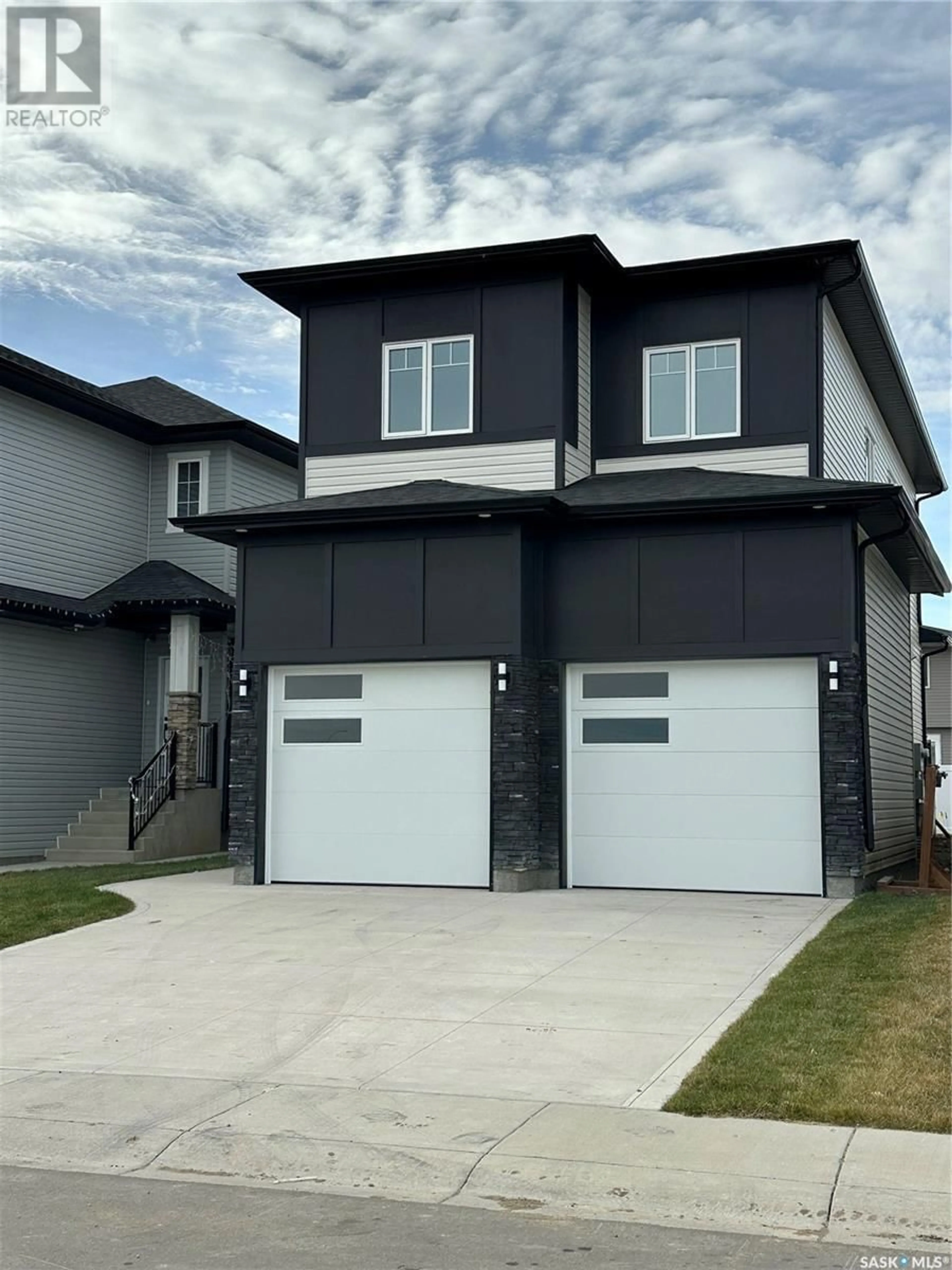 Home with vinyl exterior material, street for 714 Delainey COURT, Saskatoon Saskatchewan S0K2T0