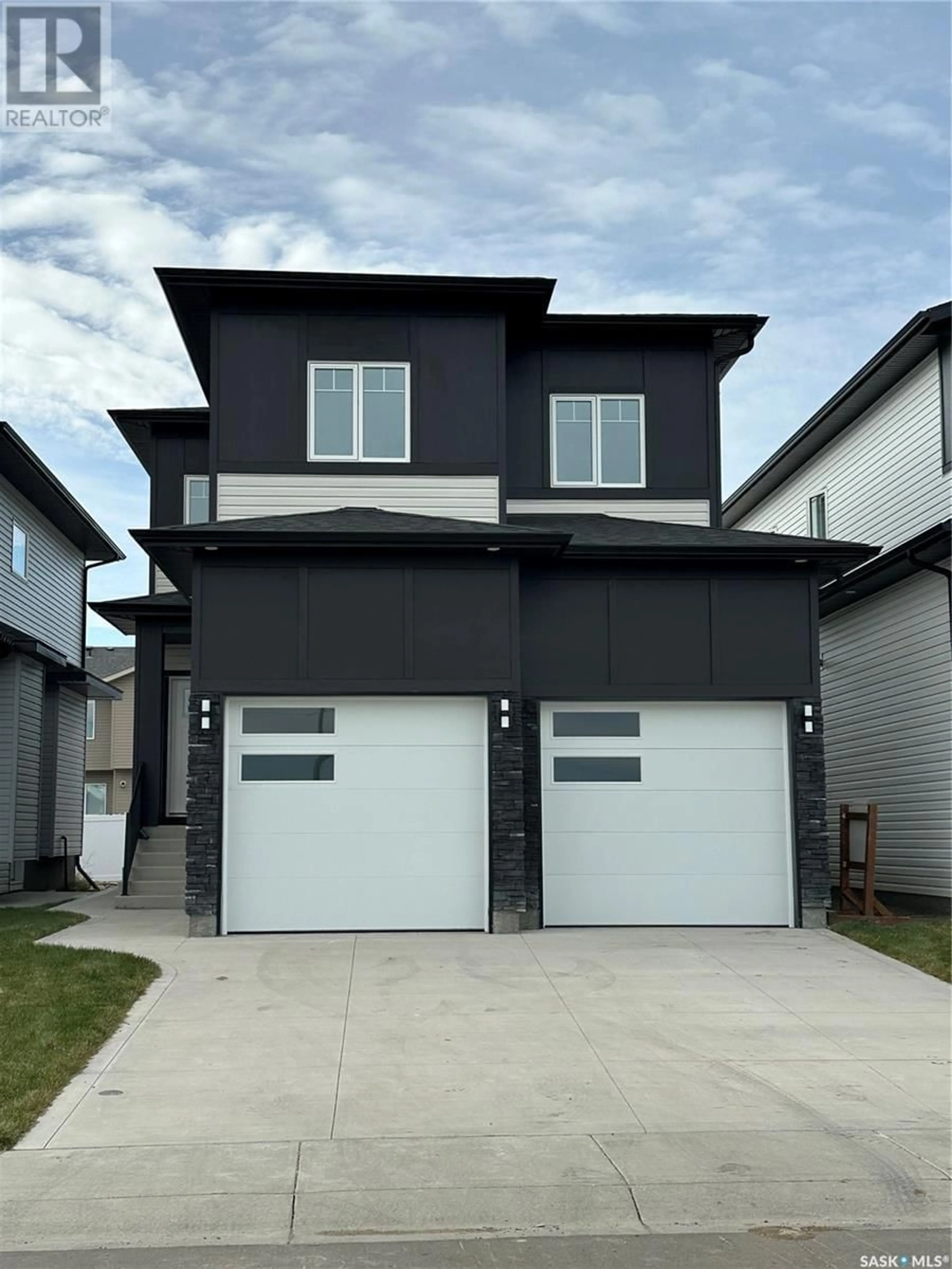 Home with vinyl exterior material, street for 714 Delainey COURT, Saskatoon Saskatchewan S0K2T0