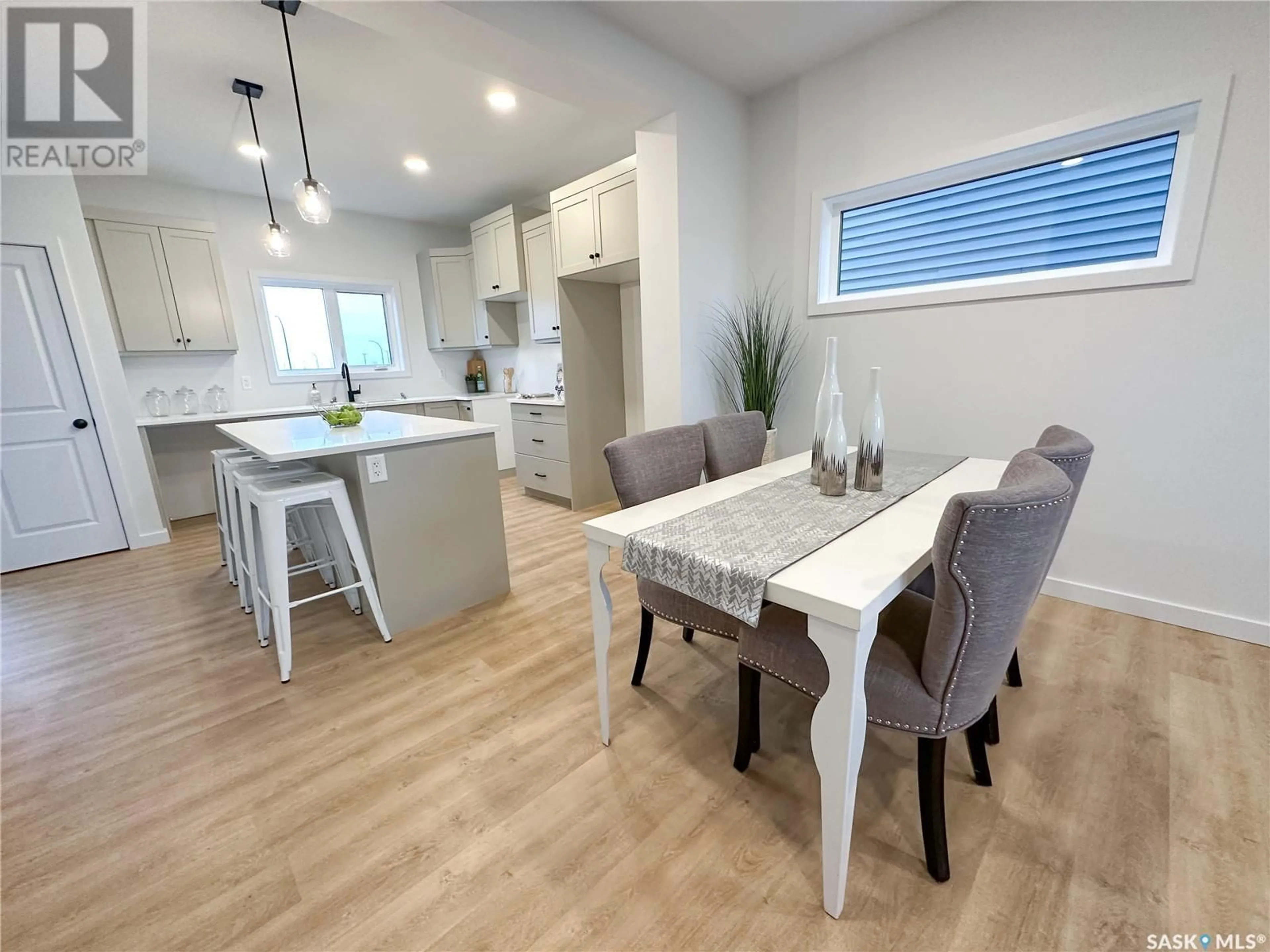 Open concept kitchen, wood/laminate floor for 748 Henry Dayday ROAD, Saskatoon Saskatchewan S7W1E2