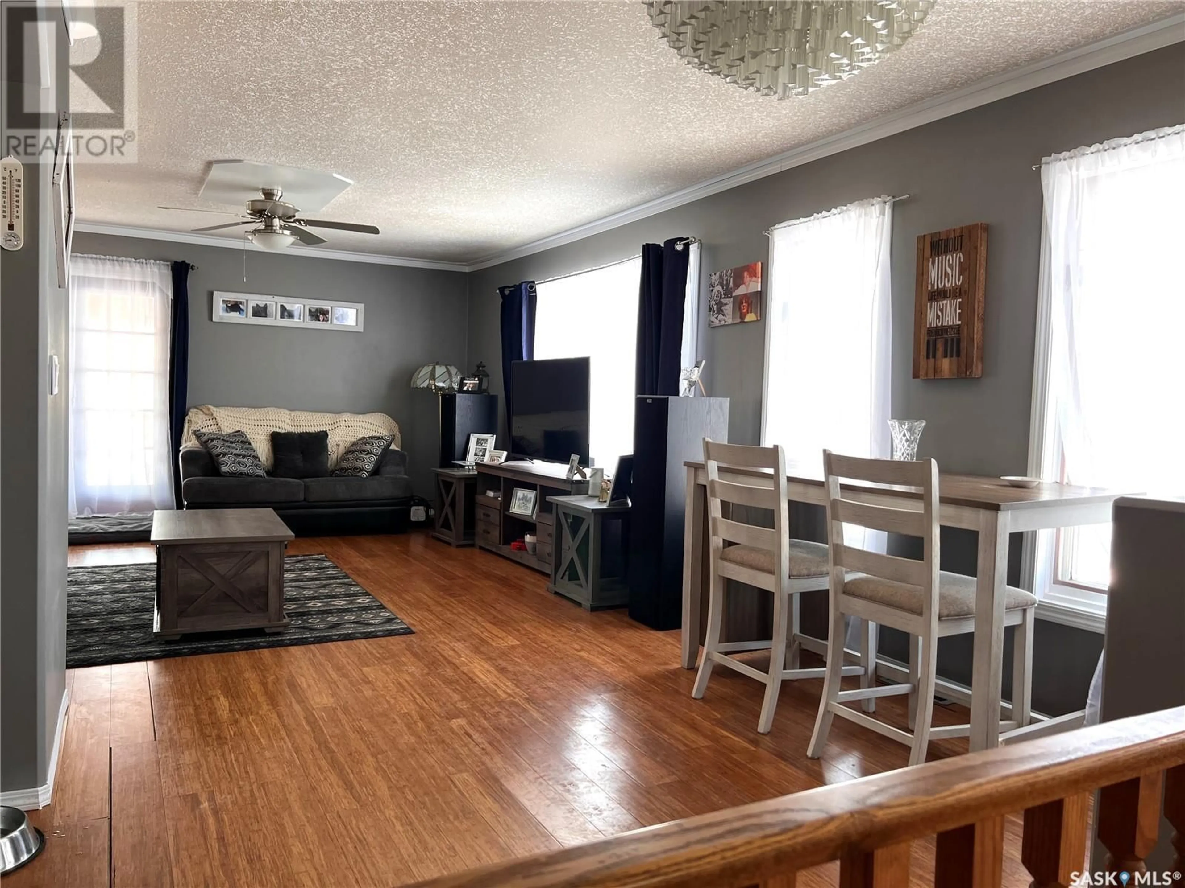 Living room with furniture, wood/laminate floor for Springburn Acreage, Wynyard Saskatchewan S0A4T0