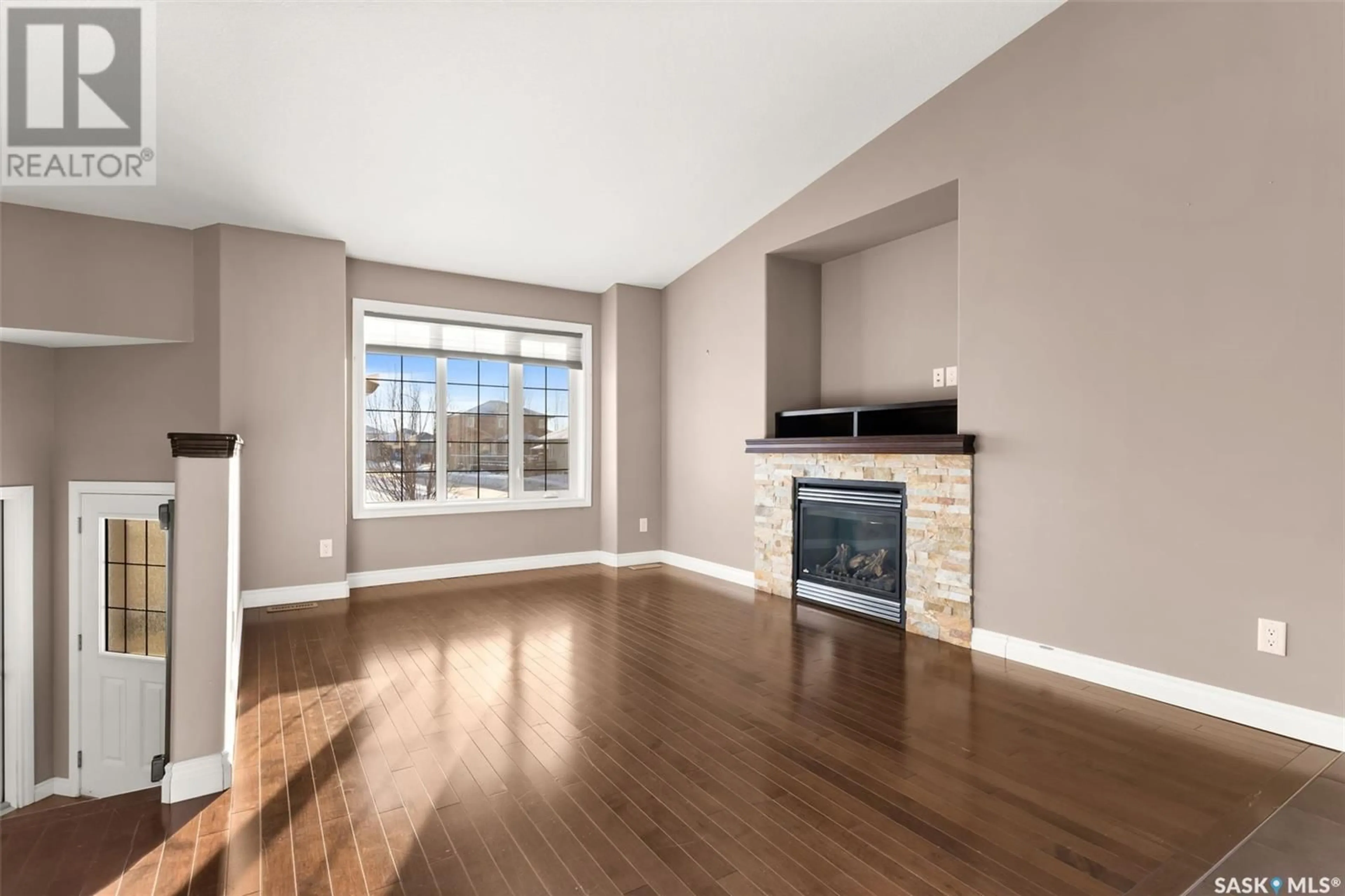 Living room with furniture, wood/laminate floor for 4418 GUSWAY STREET, Regina Saskatchewan S4X0C8