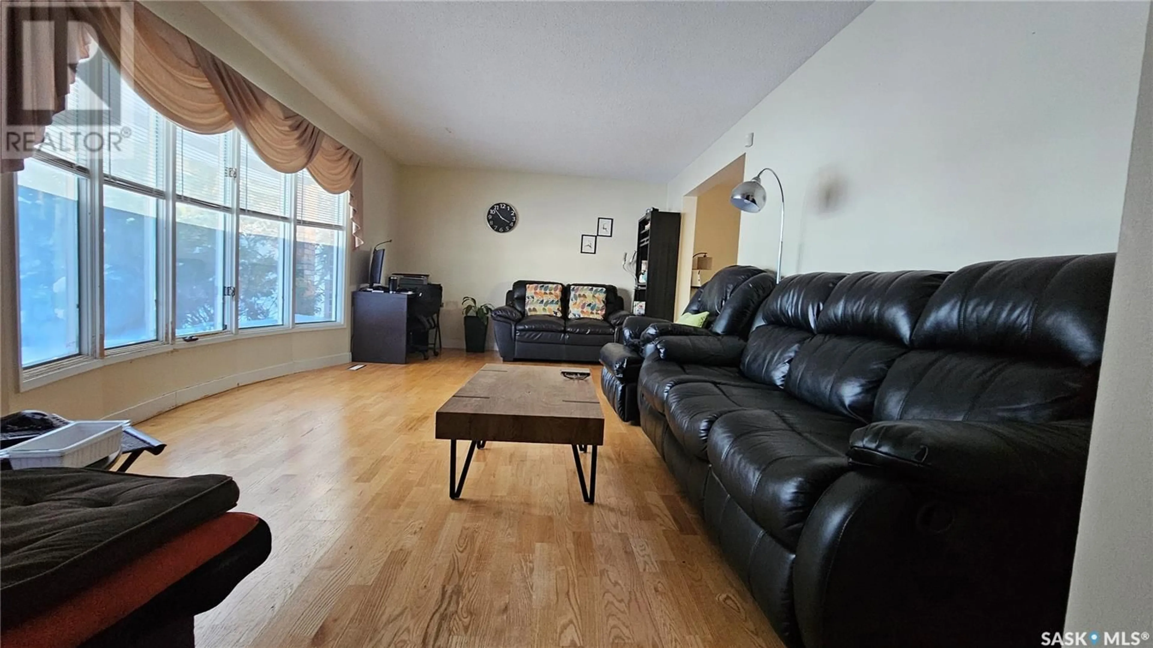 Living room with furniture, wood/laminate floor for 392 HABKIRK DRIVE, Regina Saskatchewan S4S6B1