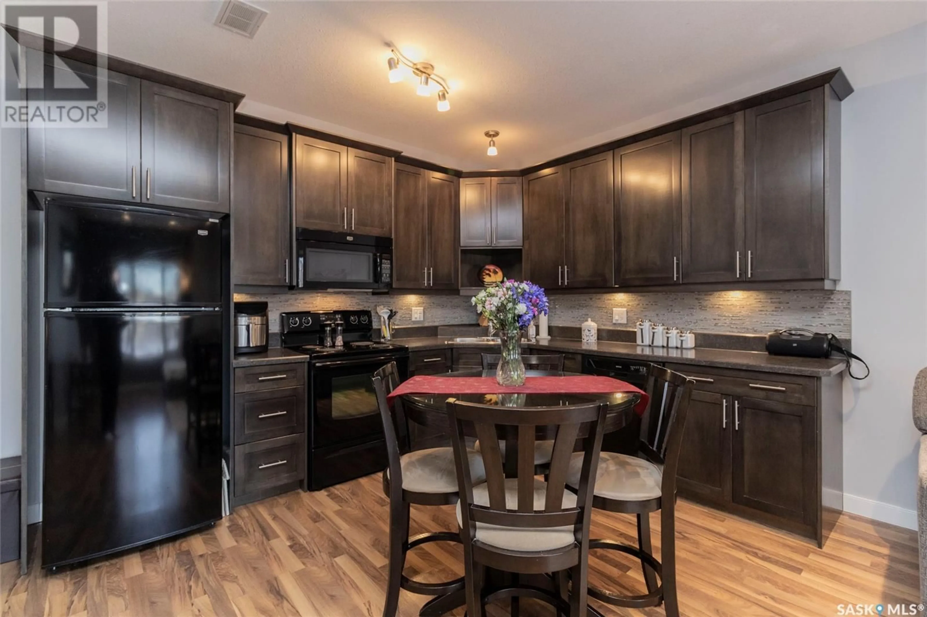 Open concept kitchen, wood/laminate floor for 29 215 Hampton GREEN, Saskatoon Saskatchewan S7R0G7