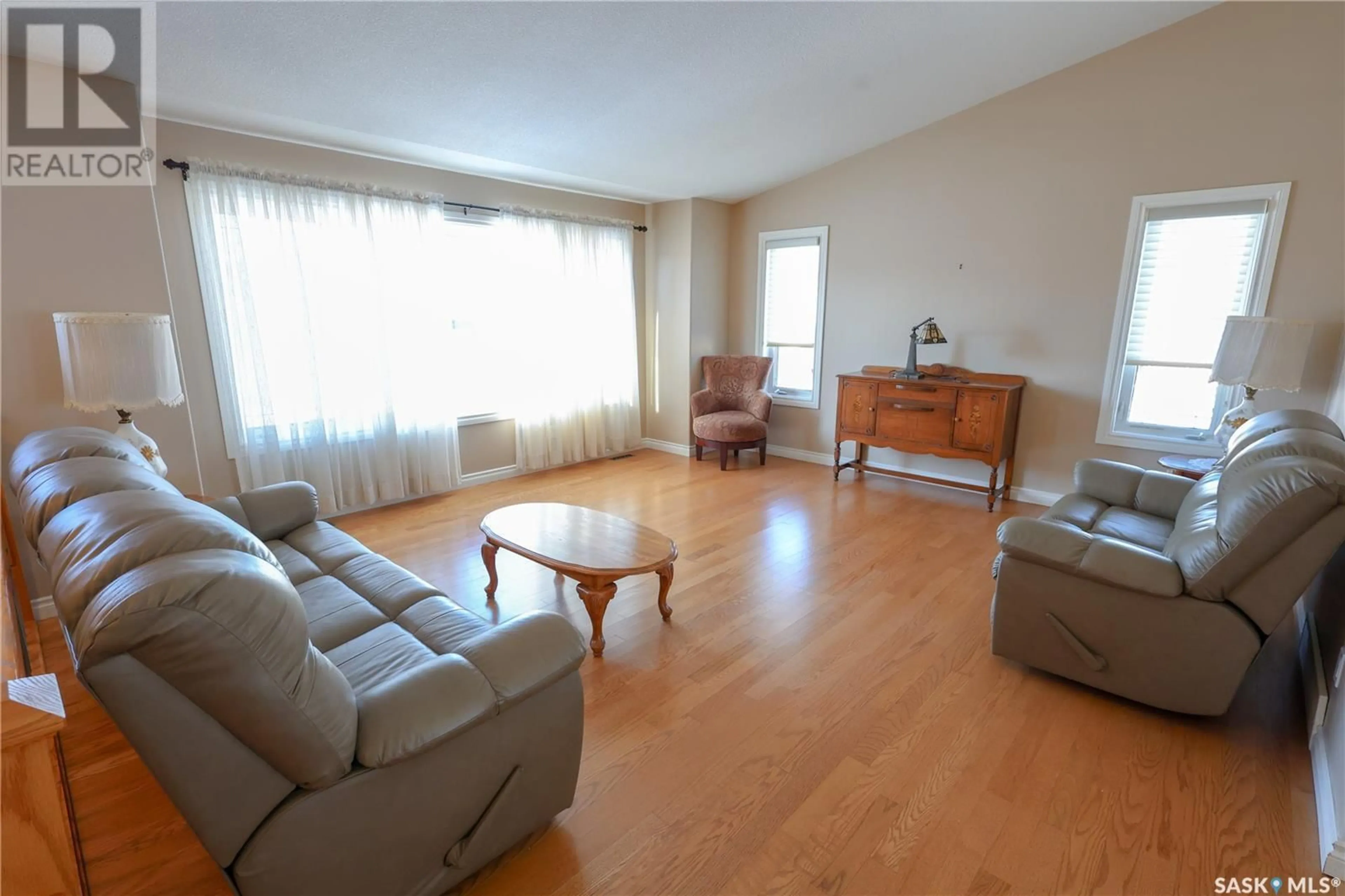 Living room with furniture, wood/laminate floor for 20 Damour TERRACE, Prince Albert Saskatchewan S6X1C9