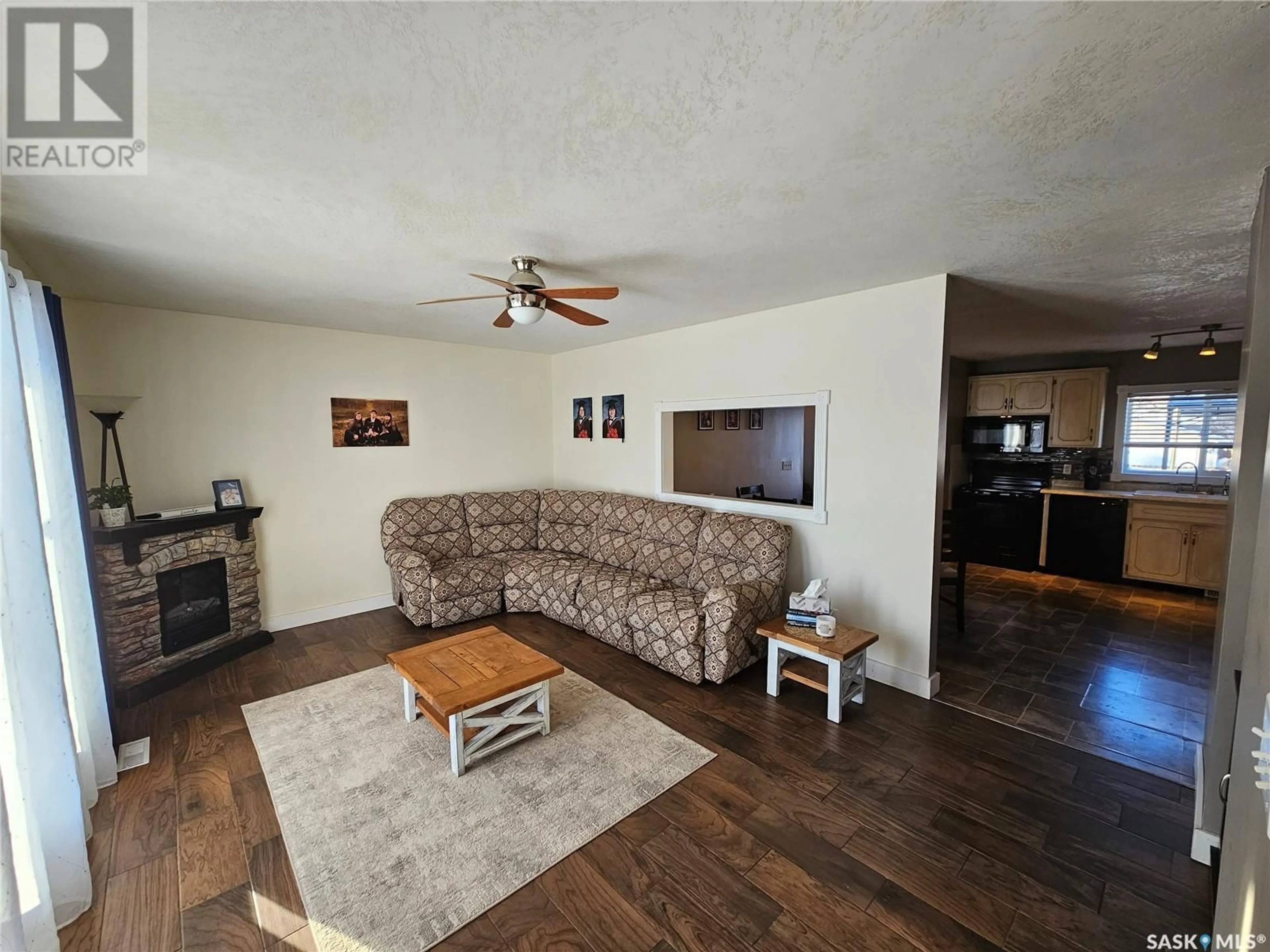 Living room with furniture, wood/laminate floor for 105 Percy STREET, Arcola Saskatchewan S0C0G0