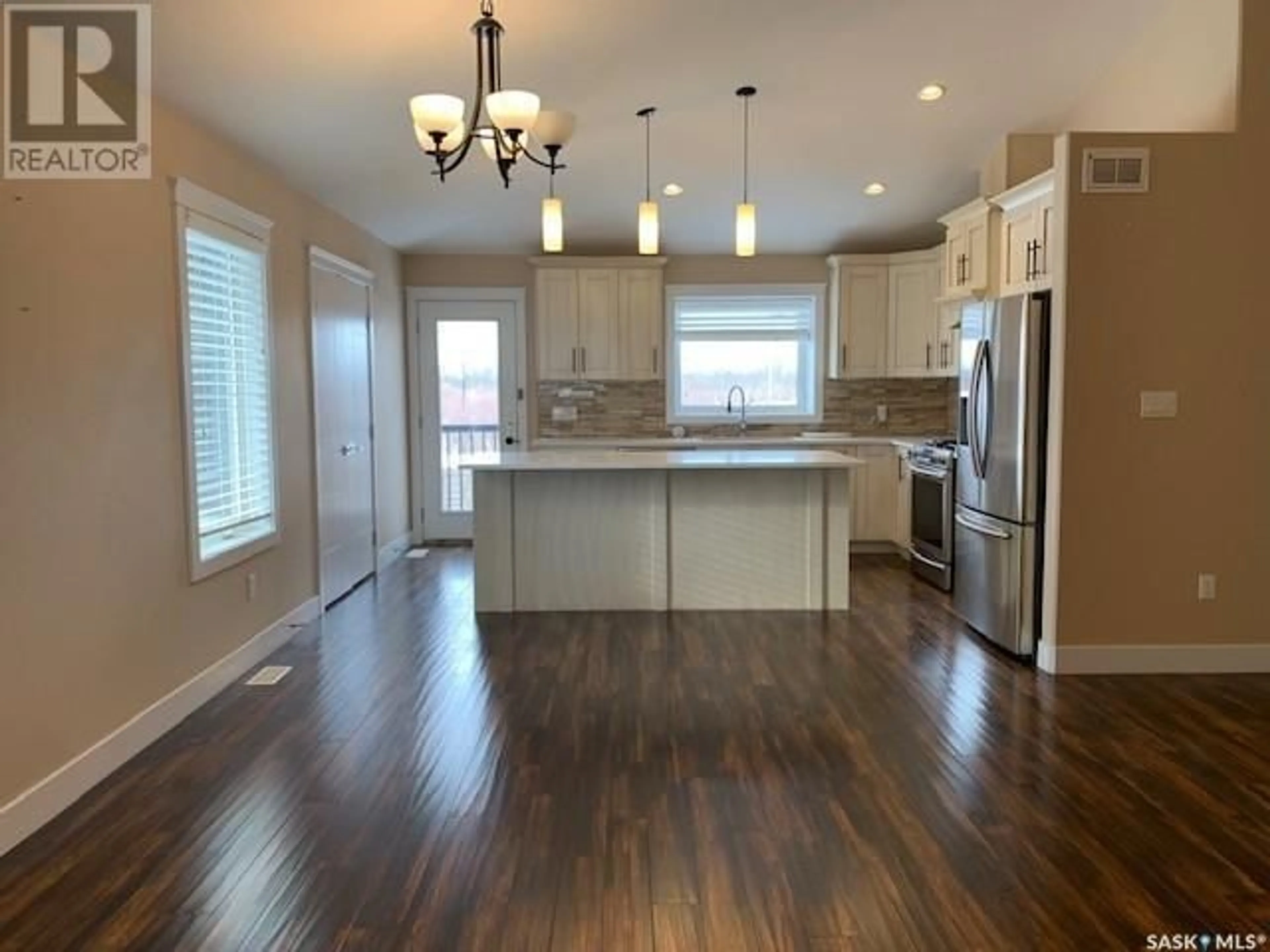 Open concept kitchen, wood/laminate floor for 129 Cowan CRESCENT, Martensville Saskatchewan S0K2T1