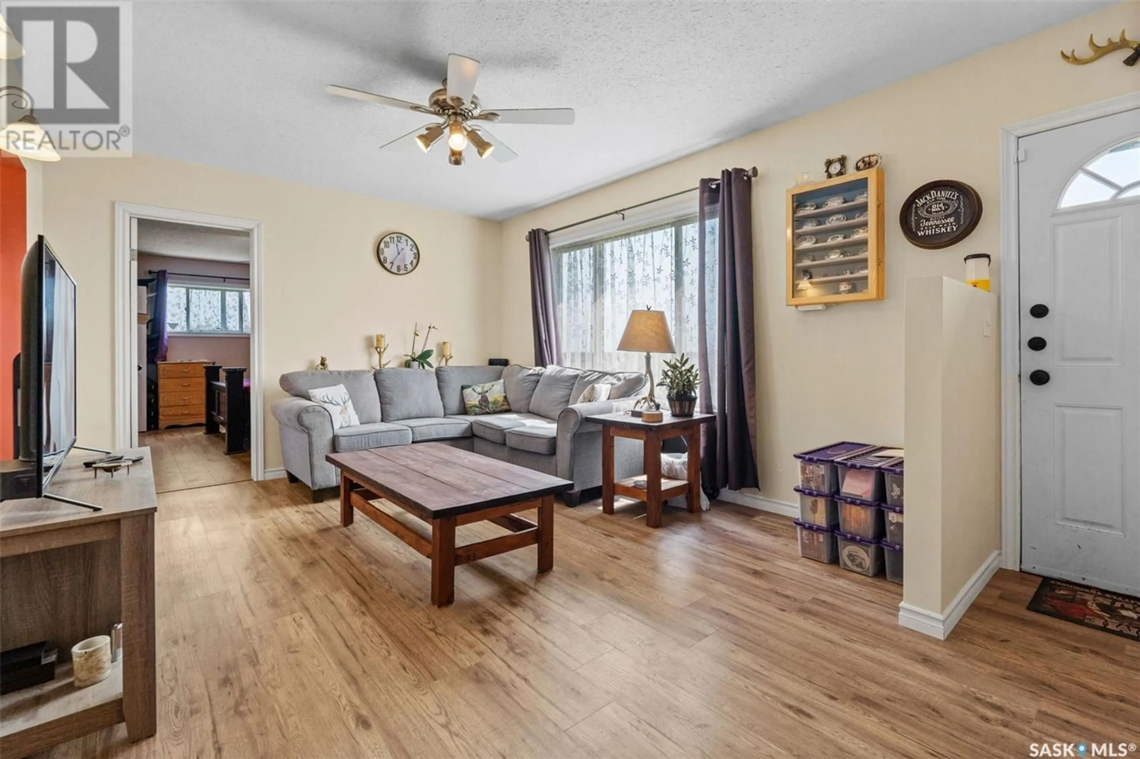 Living room with furniture, wood/laminate floor for Norris acreage, Perdue Rm No. 346 Saskatchewan S0K0J0