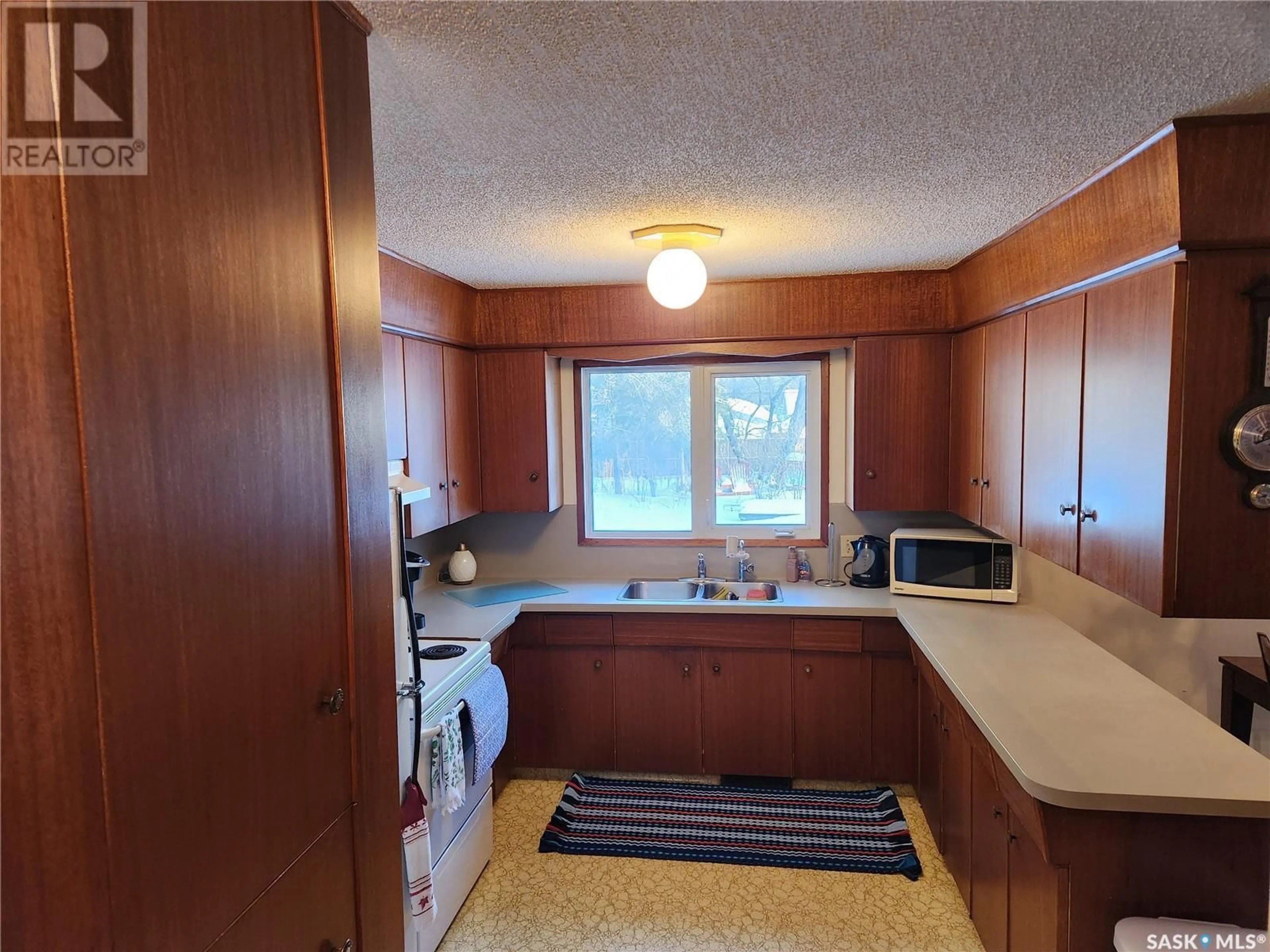 Home with vinyl exterior material, street for 1504 98TH STREET, Tisdale Saskatchewan S0E1T0
