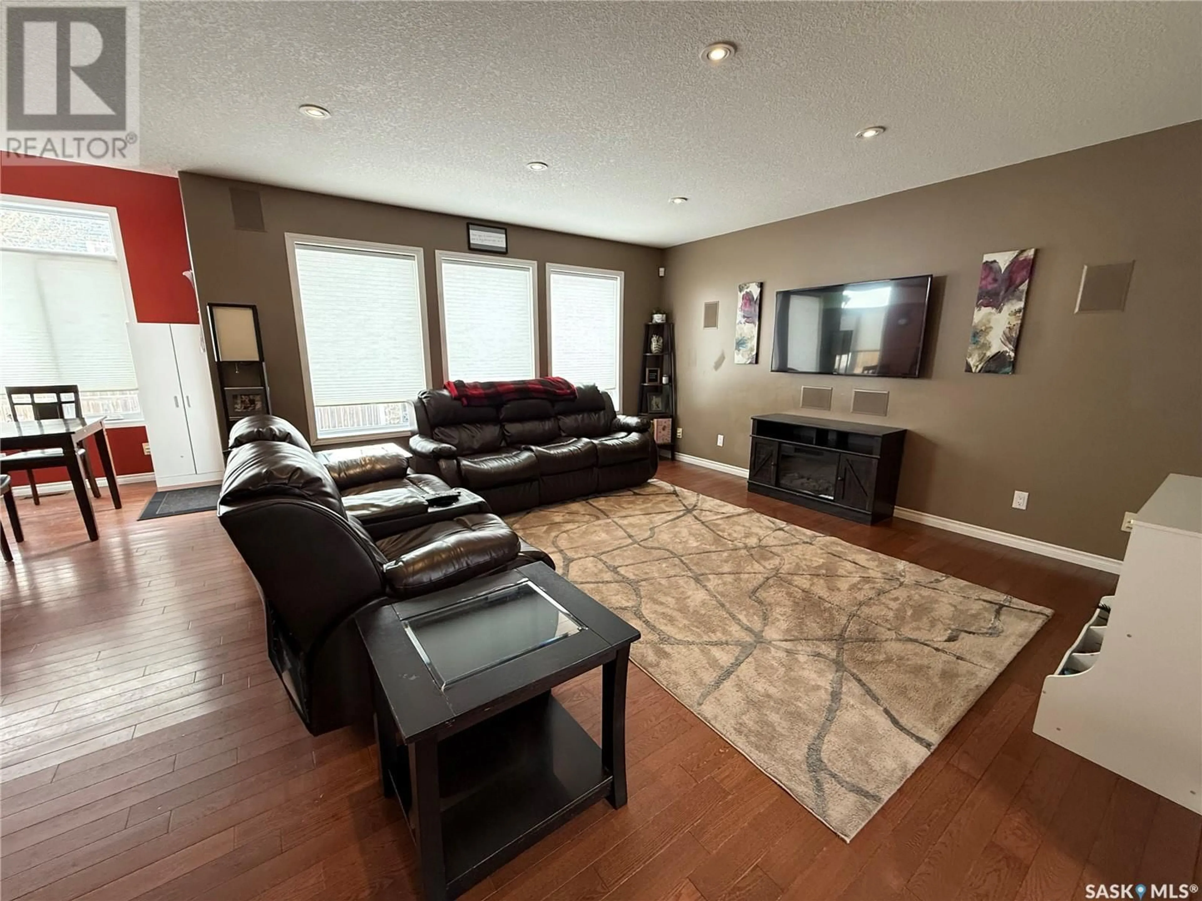 Living room with furniture, wood/laminate floor for 1774 Wellock ROAD, Estevan Saskatchewan S4A2W1