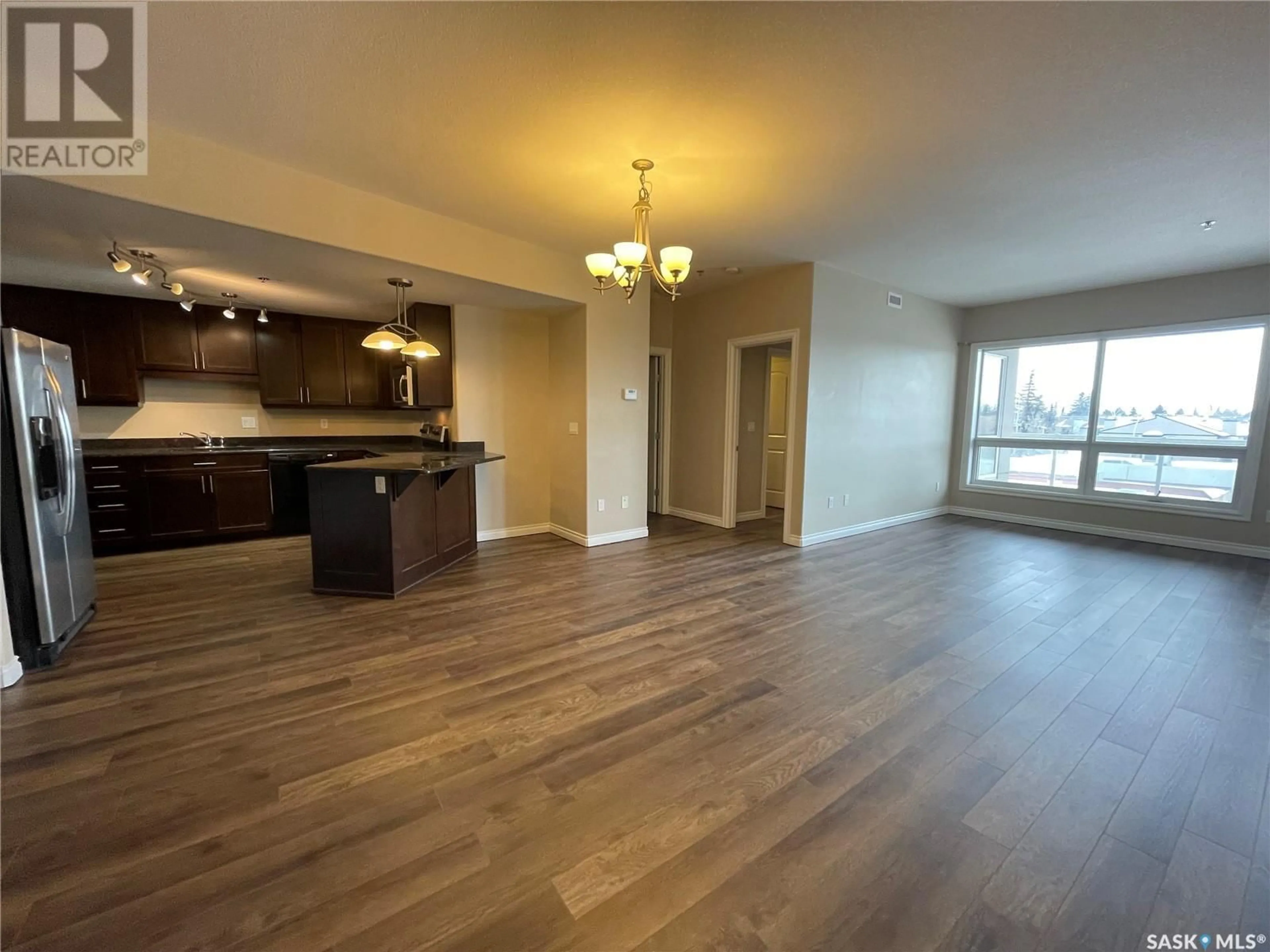 Open concept kitchen, wood/laminate floor for 310 227 Pinehouse DRIVE, Saskatoon Saskatchewan S7K6N9