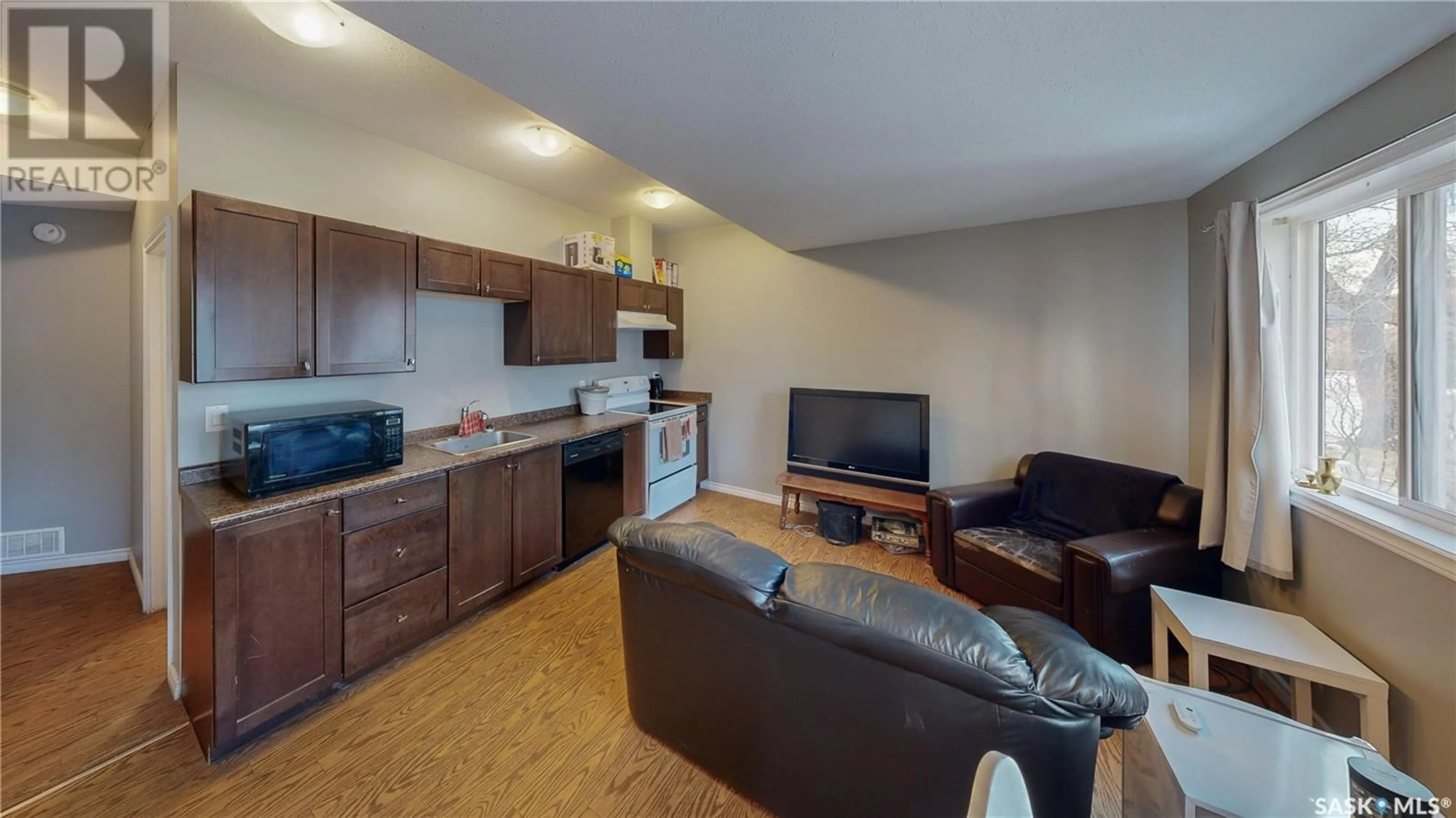 Living room with furniture, wood/laminate floor for A and B 2267 Cameron STREET, Regina Saskatchewan S4T2V9