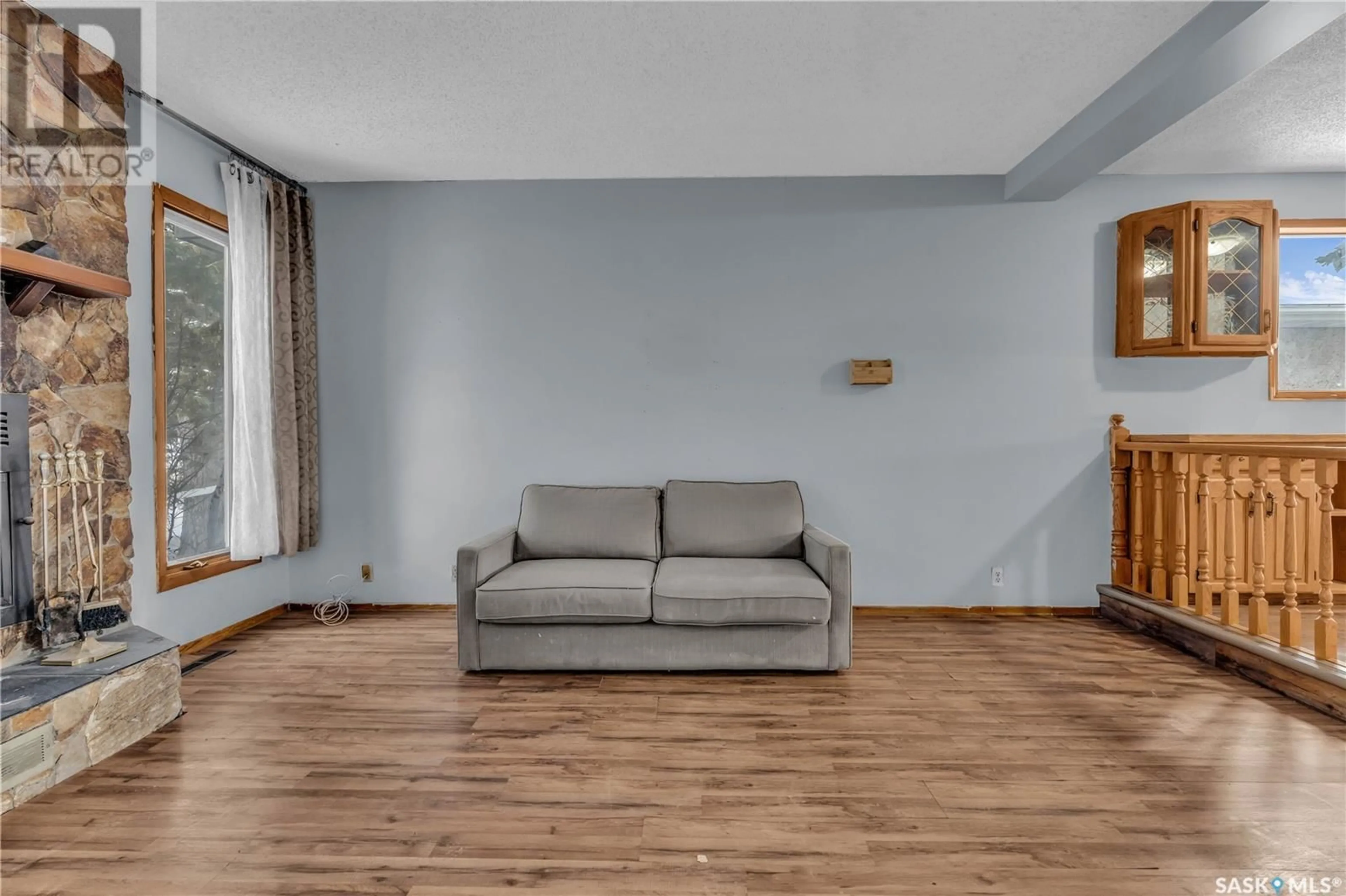 Living room with furniture, wood/laminate floor for 3519 6th AVENUE N, Regina Saskatchewan S4R0P7