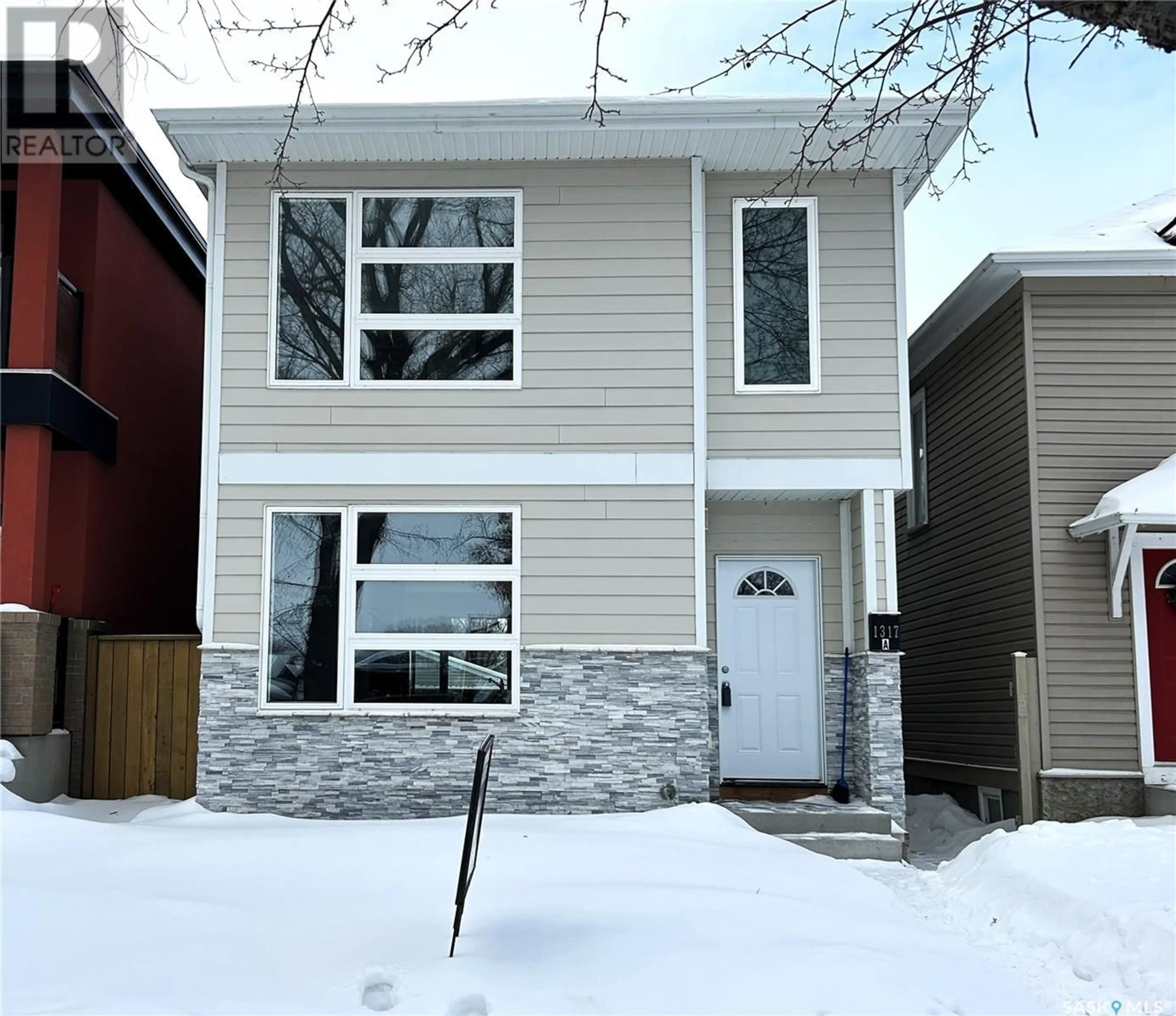 Home with vinyl exterior material, street for 1317 8th AVENUE N, Saskatoon Saskatchewan S7K2X5