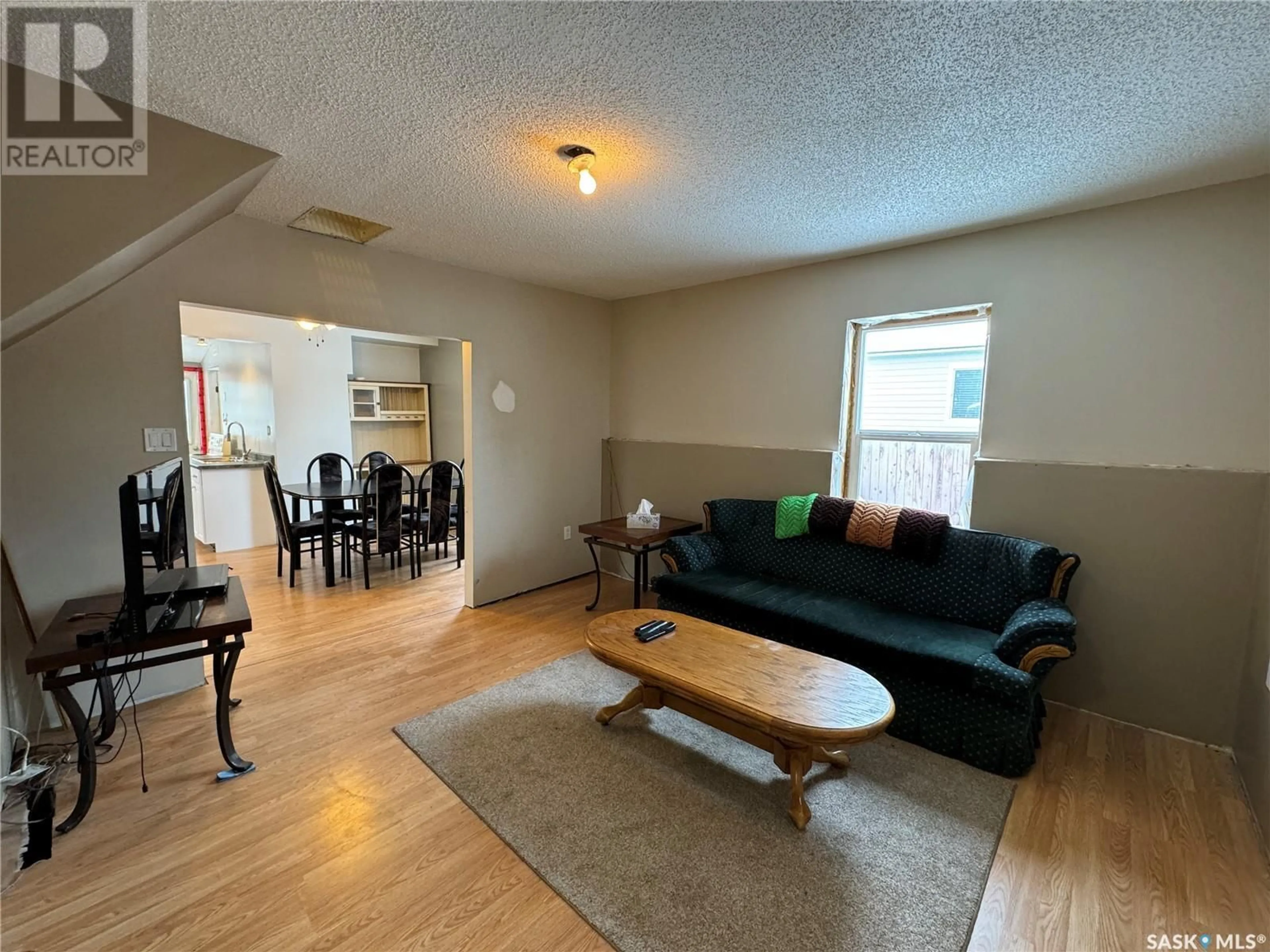 Living room with furniture, wood/laminate floor for 112 4th AVENUE W, Biggar Saskatchewan S0K0M0