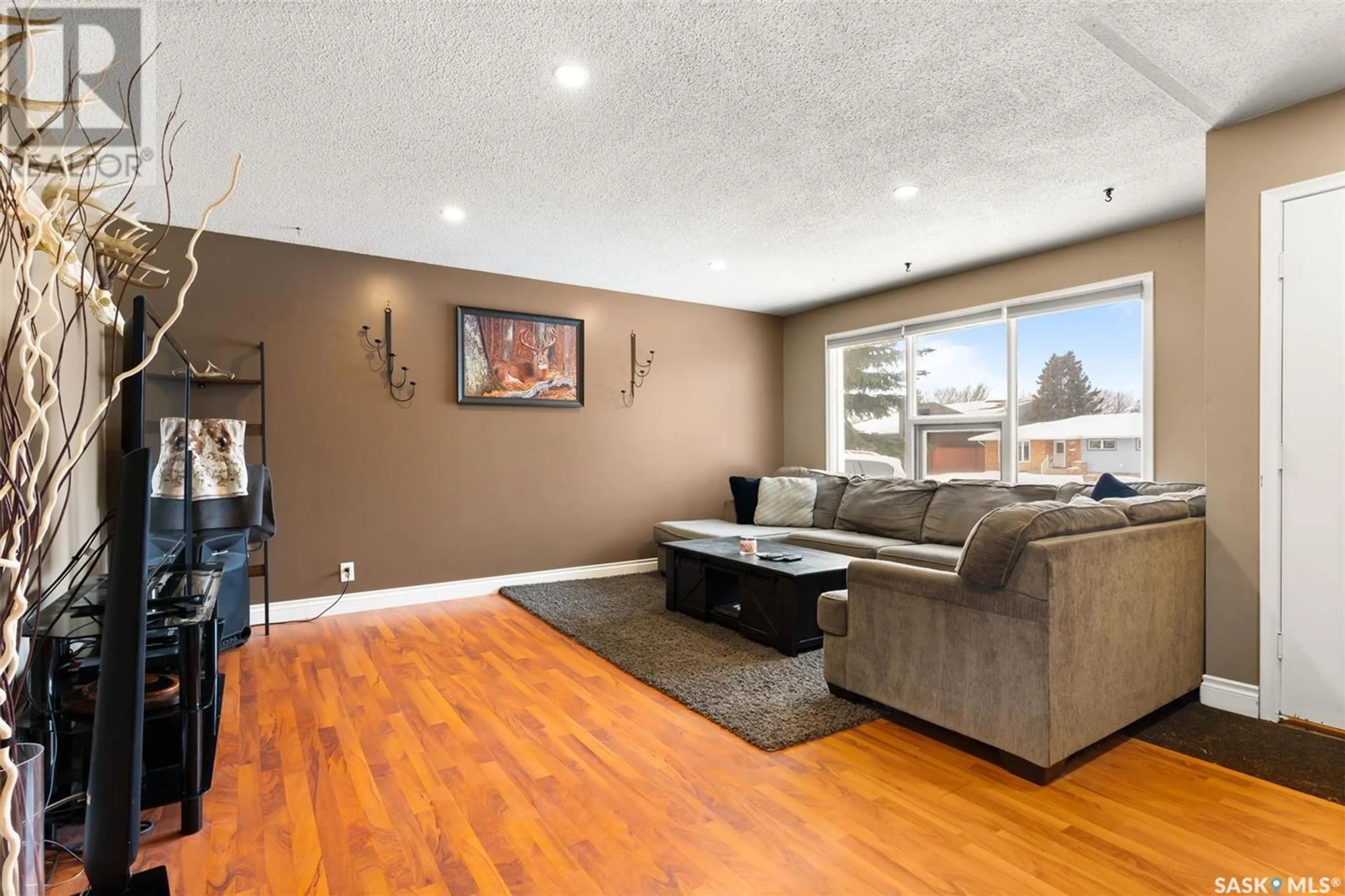 Living room with furniture, wood/laminate floor for 419 McIntosh STREET N, Regina Saskatchewan S4R5A3