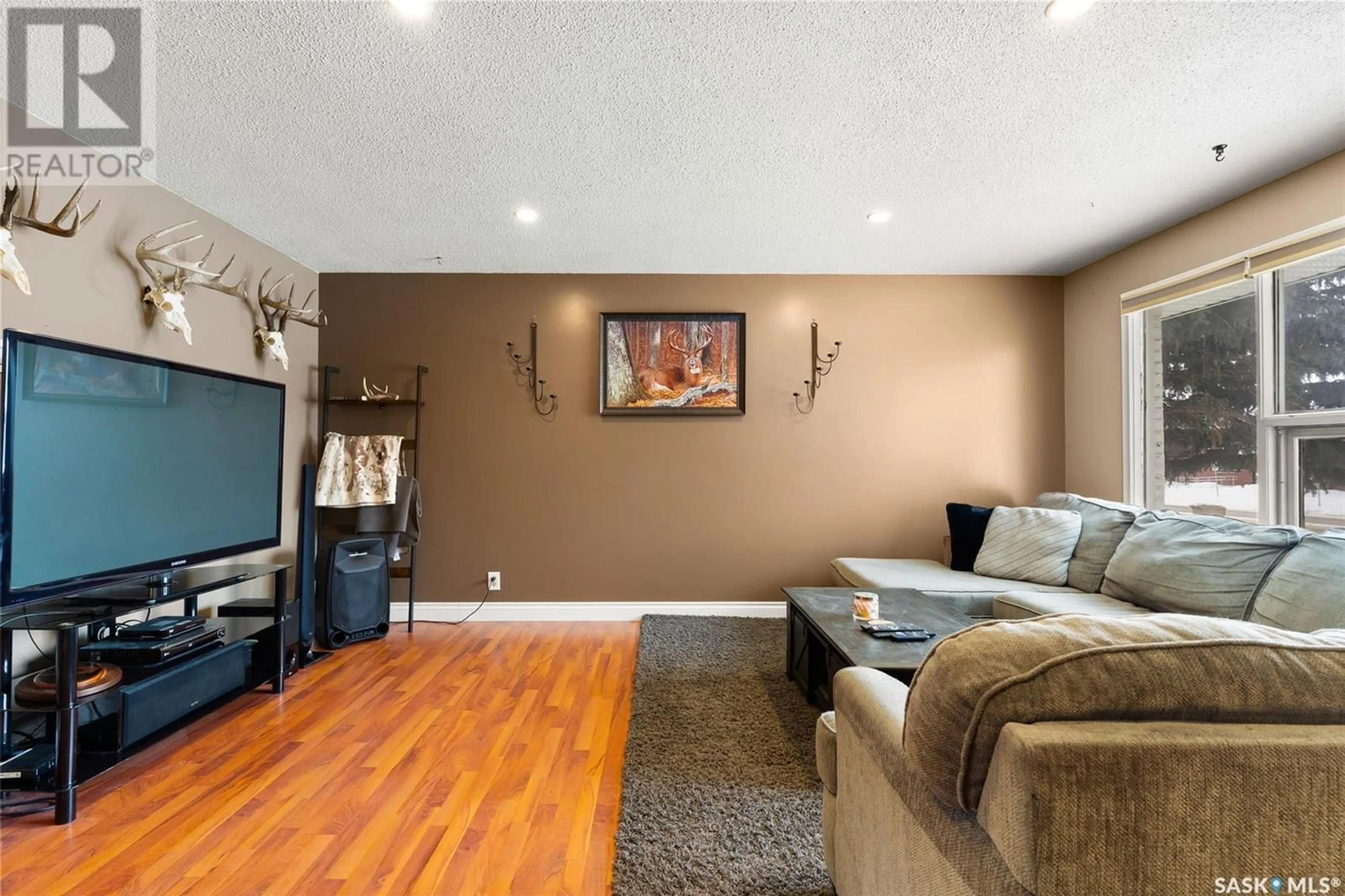 Living room with furniture, wood/laminate floor for 419 McIntosh STREET N, Regina Saskatchewan S4R5A3