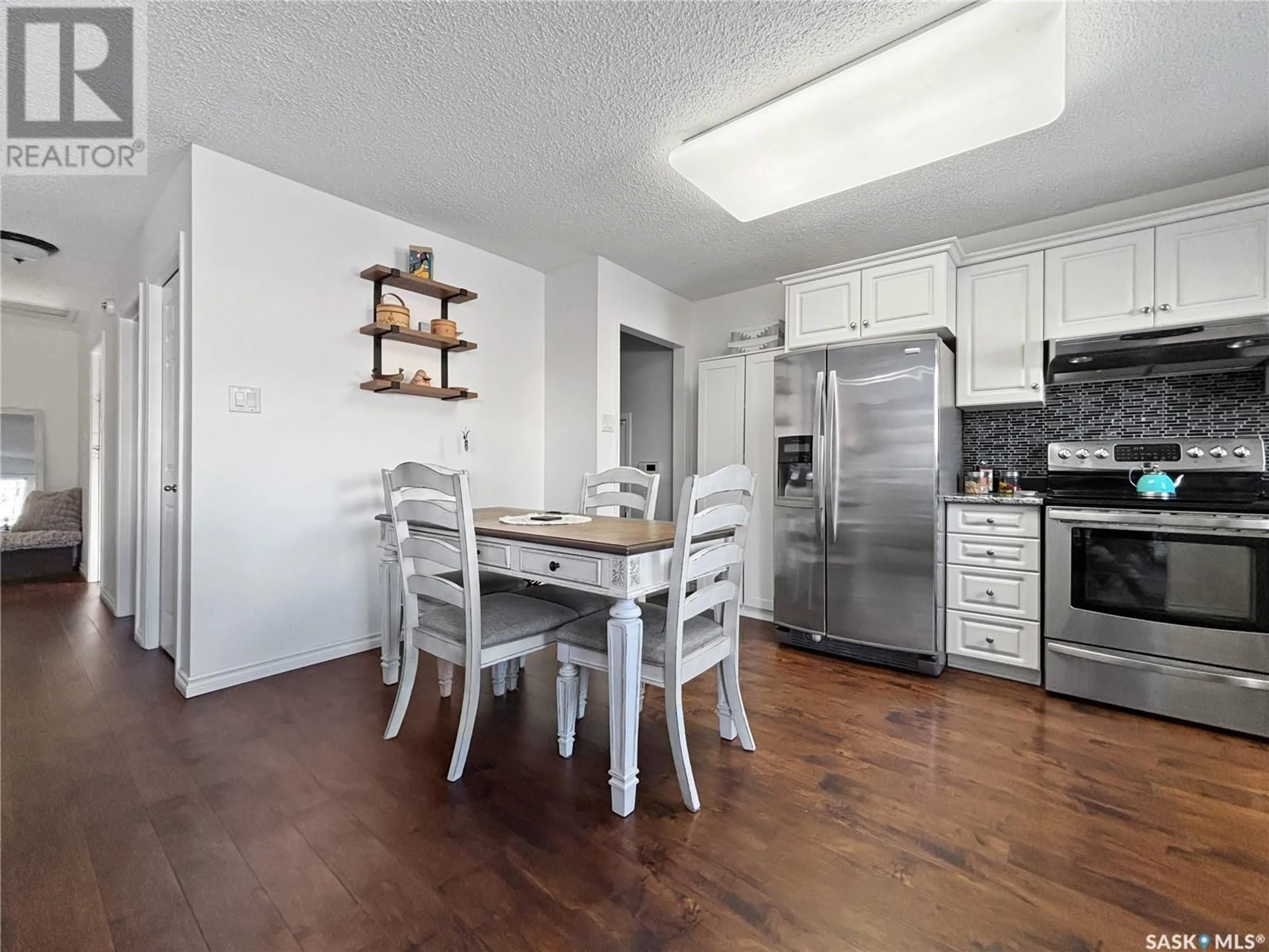 Open concept kitchen, wood/laminate floor for 439 Poth WAY, Saskatoon Saskatchewan S7M4V8