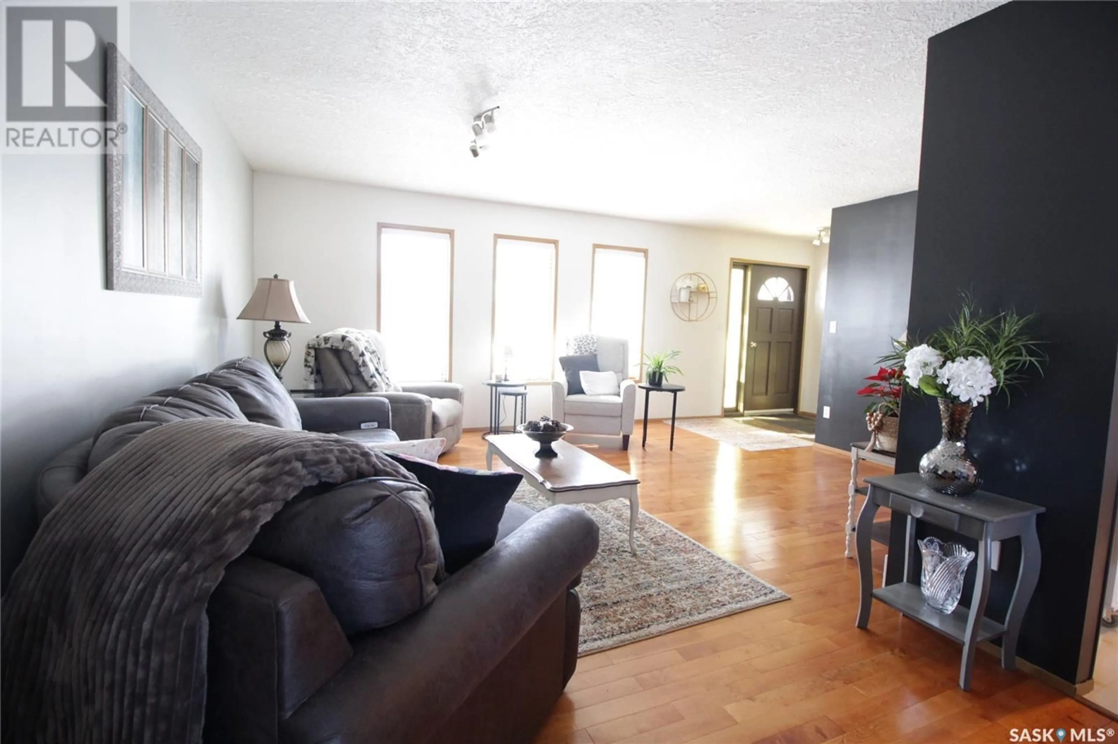 Living room with furniture, wood/laminate floor for 1504 Chestnut DRIVE, Moosomin Saskatchewan S0G3N0