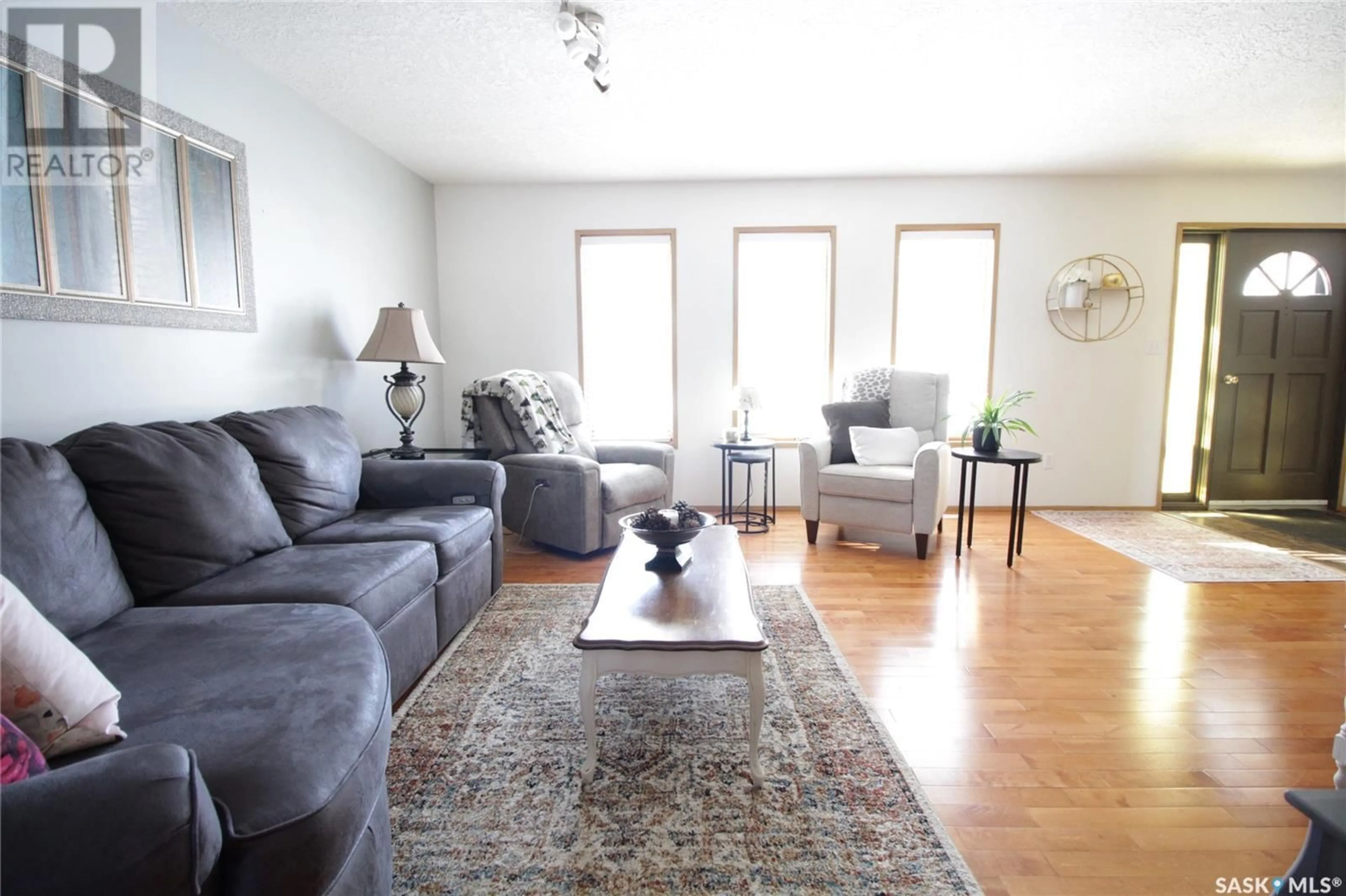 Living room with furniture, wood/laminate floor for 1504 Chestnut DRIVE, Moosomin Saskatchewan S0G3N0