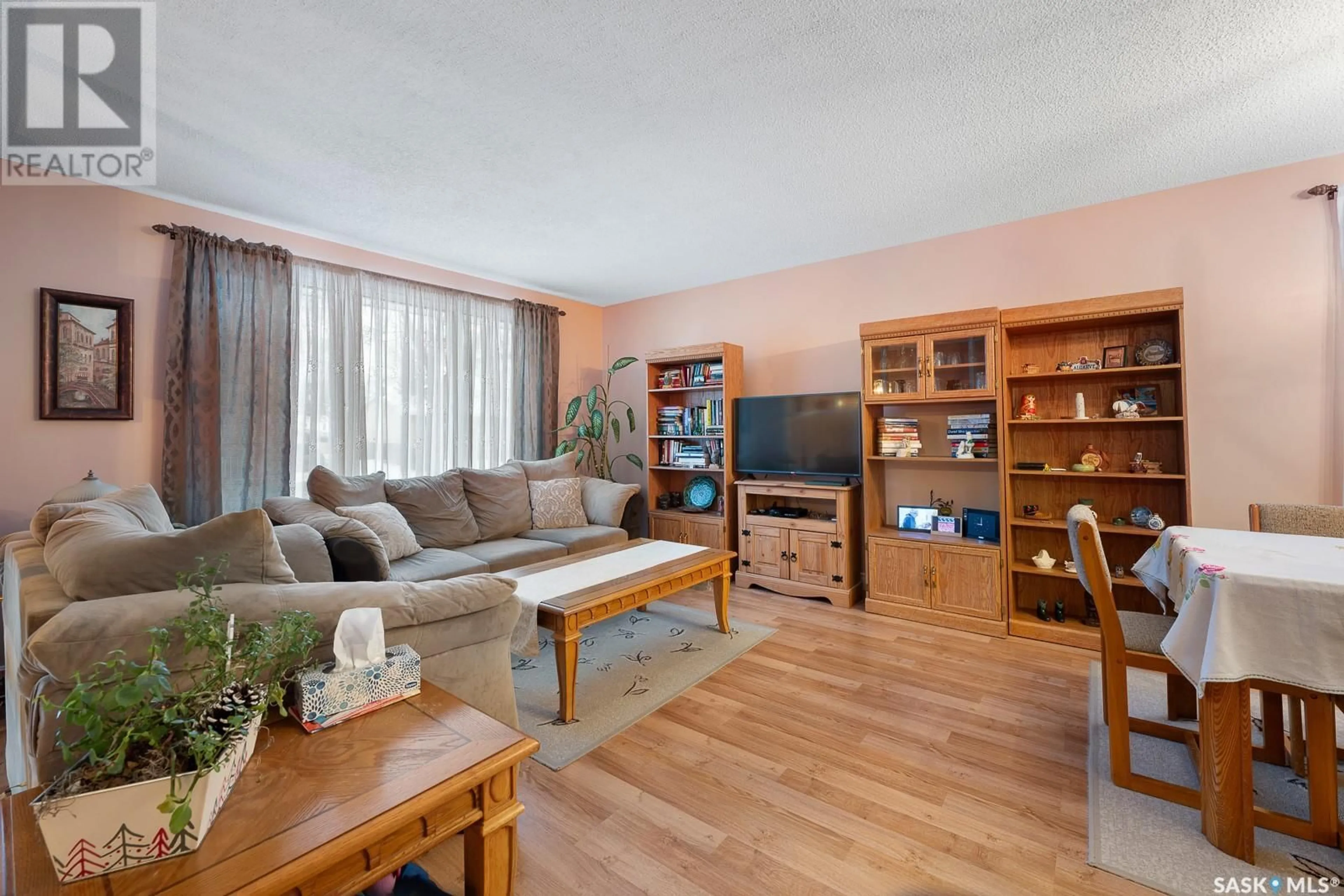 Living room with furniture, wood/laminate floor for 143 Mikkelson DRIVE, Regina Saskatchewan S4T7L5