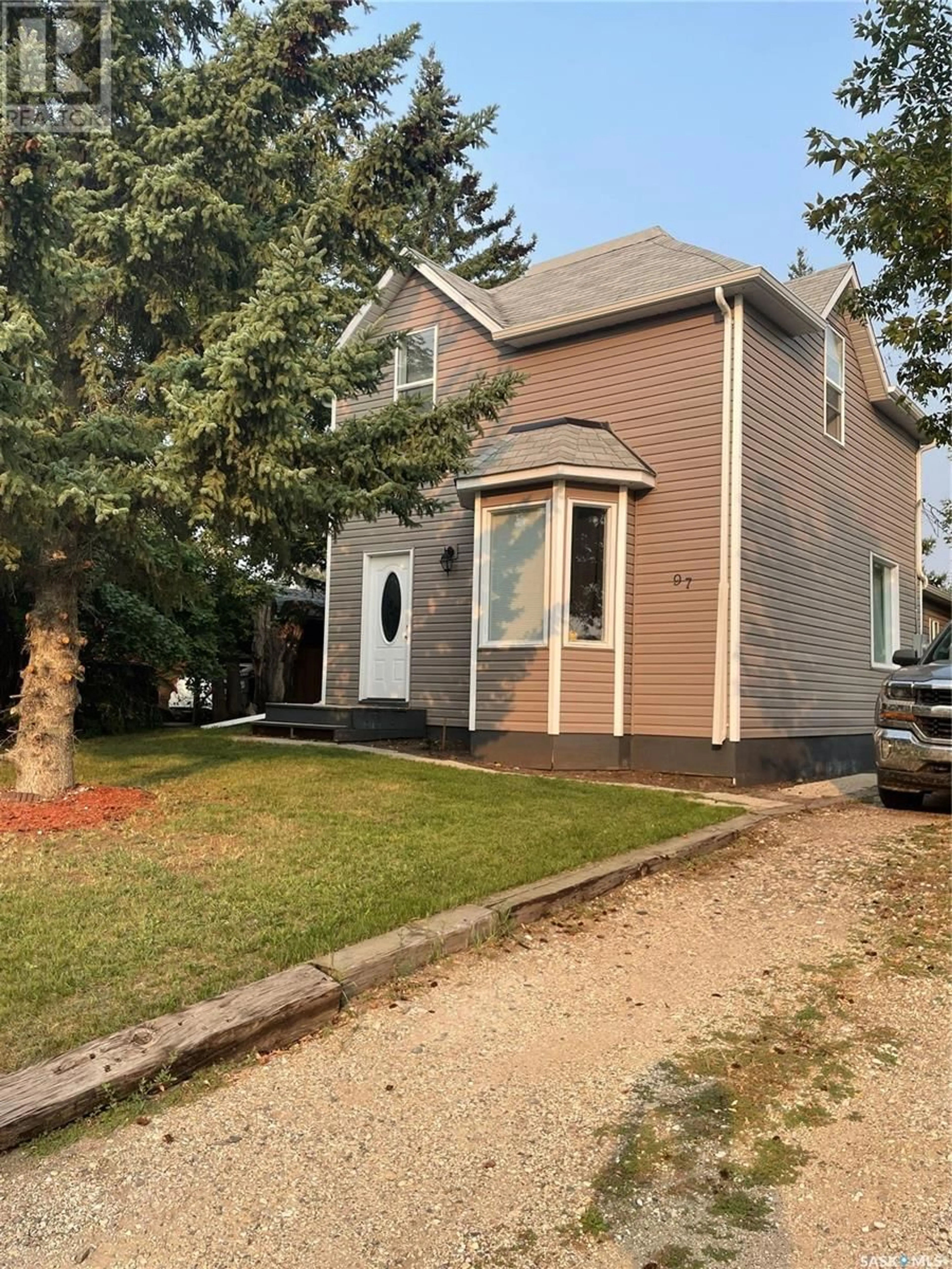 Home with vinyl exterior material, street for 97 Main STREET, Lanigan Saskatchewan S0K2M0