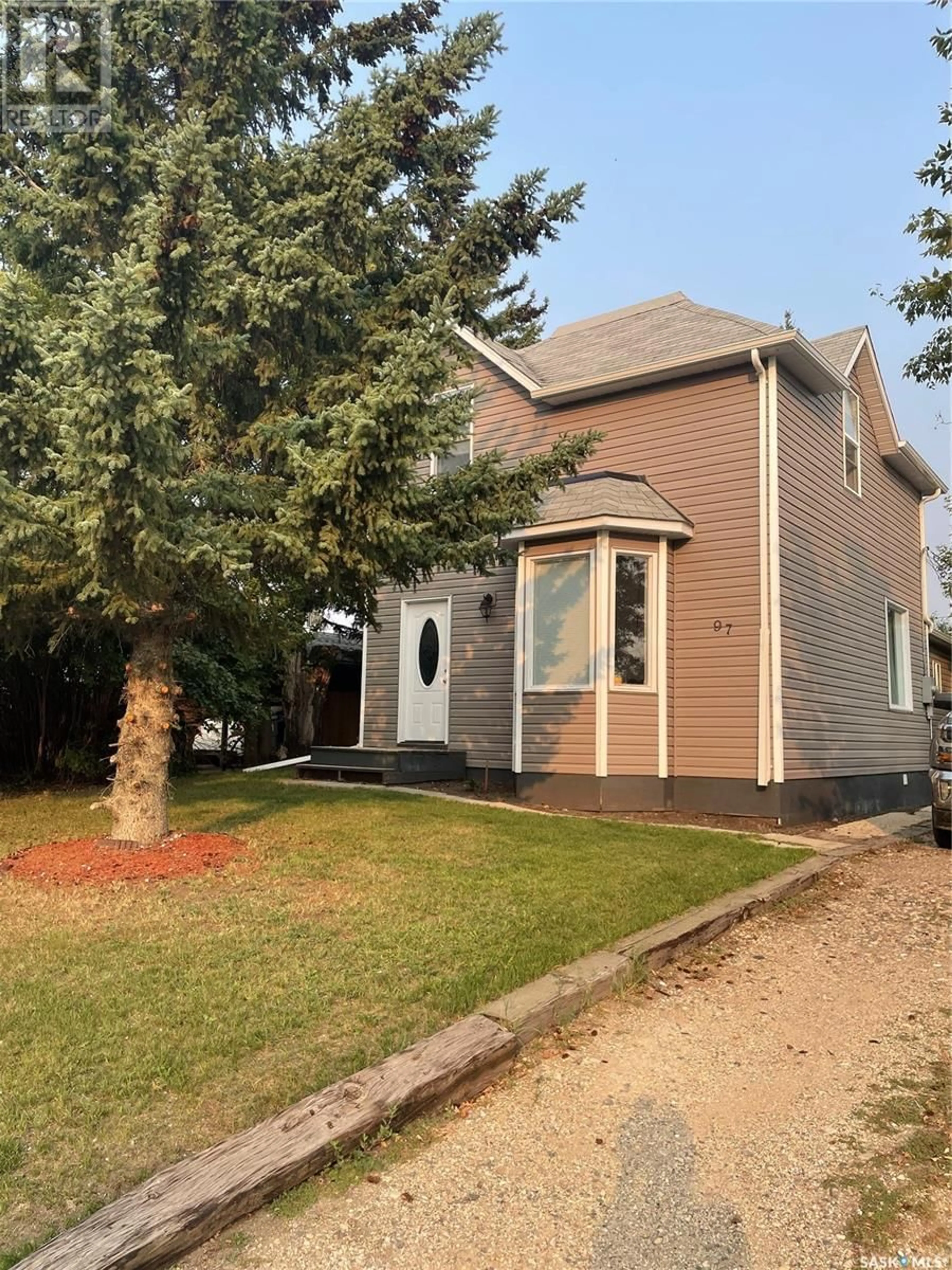 Home with vinyl exterior material, street for 97 Main STREET, Lanigan Saskatchewan S0K2M0