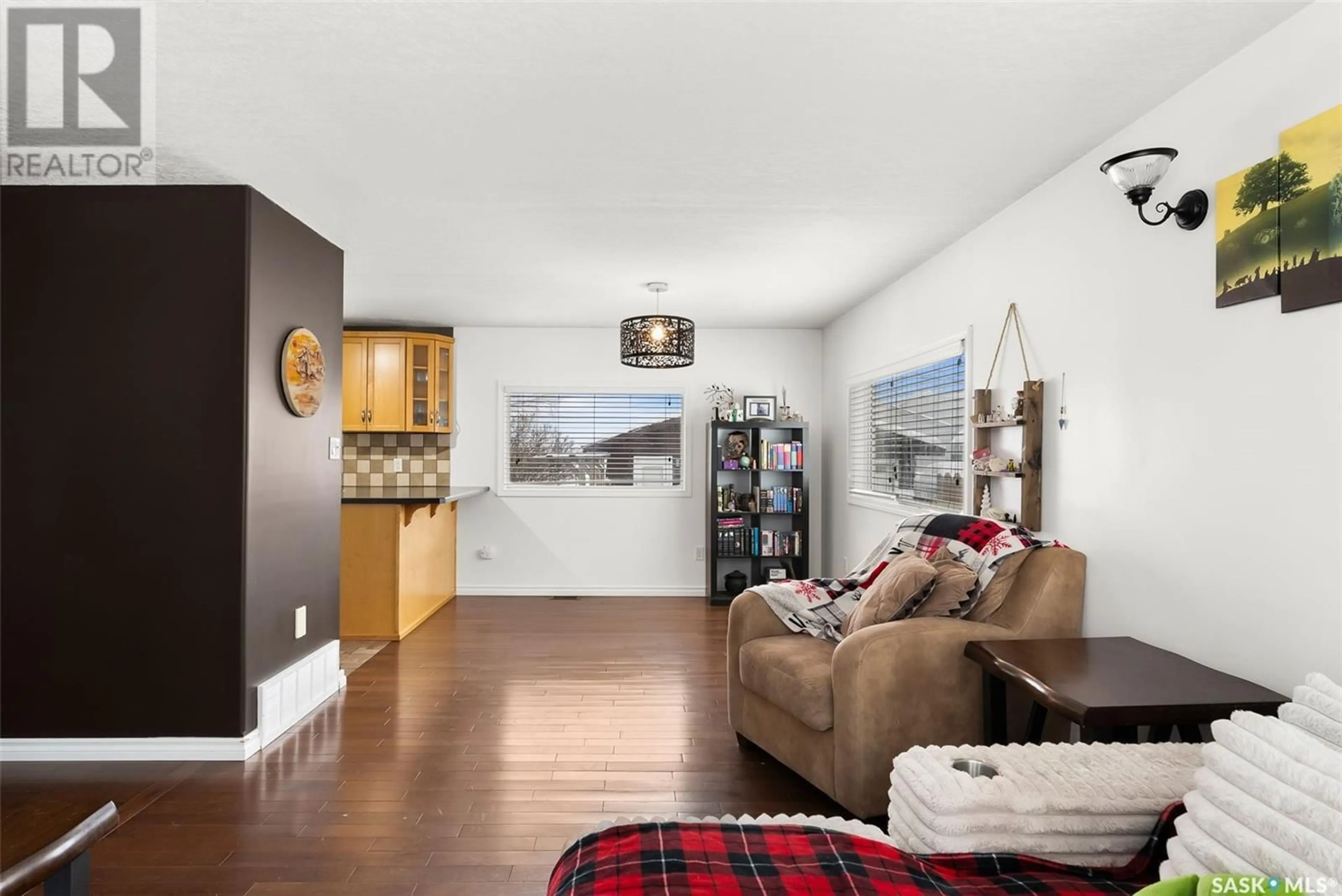 Living room with furniture, wood/laminate floor for 291 4th STREET, Pilot Butte Saskatchewan S0G3Z0