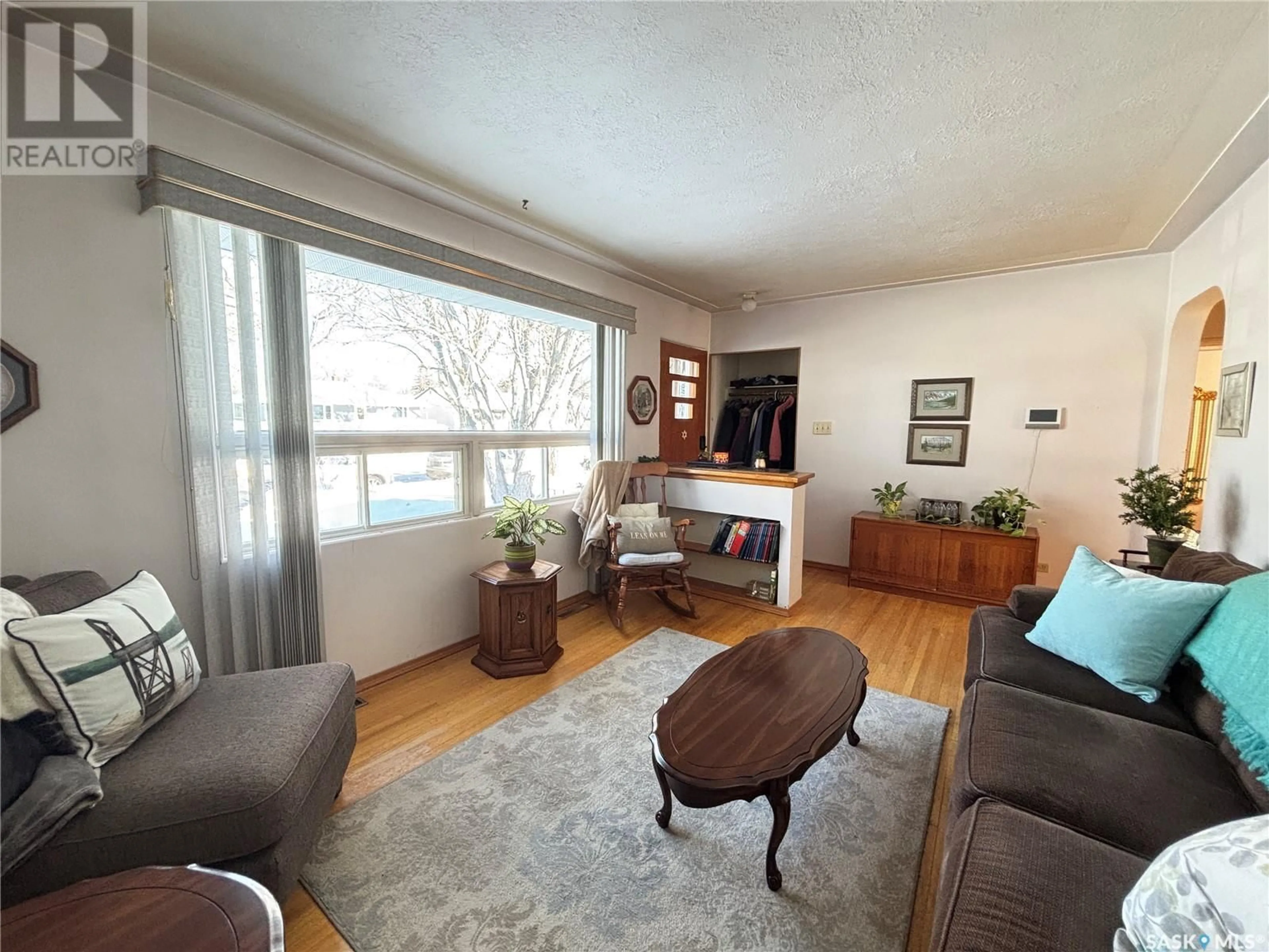 Living room with furniture, wood/laminate floor for 5313 3rd AVENUE, Regina Saskatchewan S4T0G3