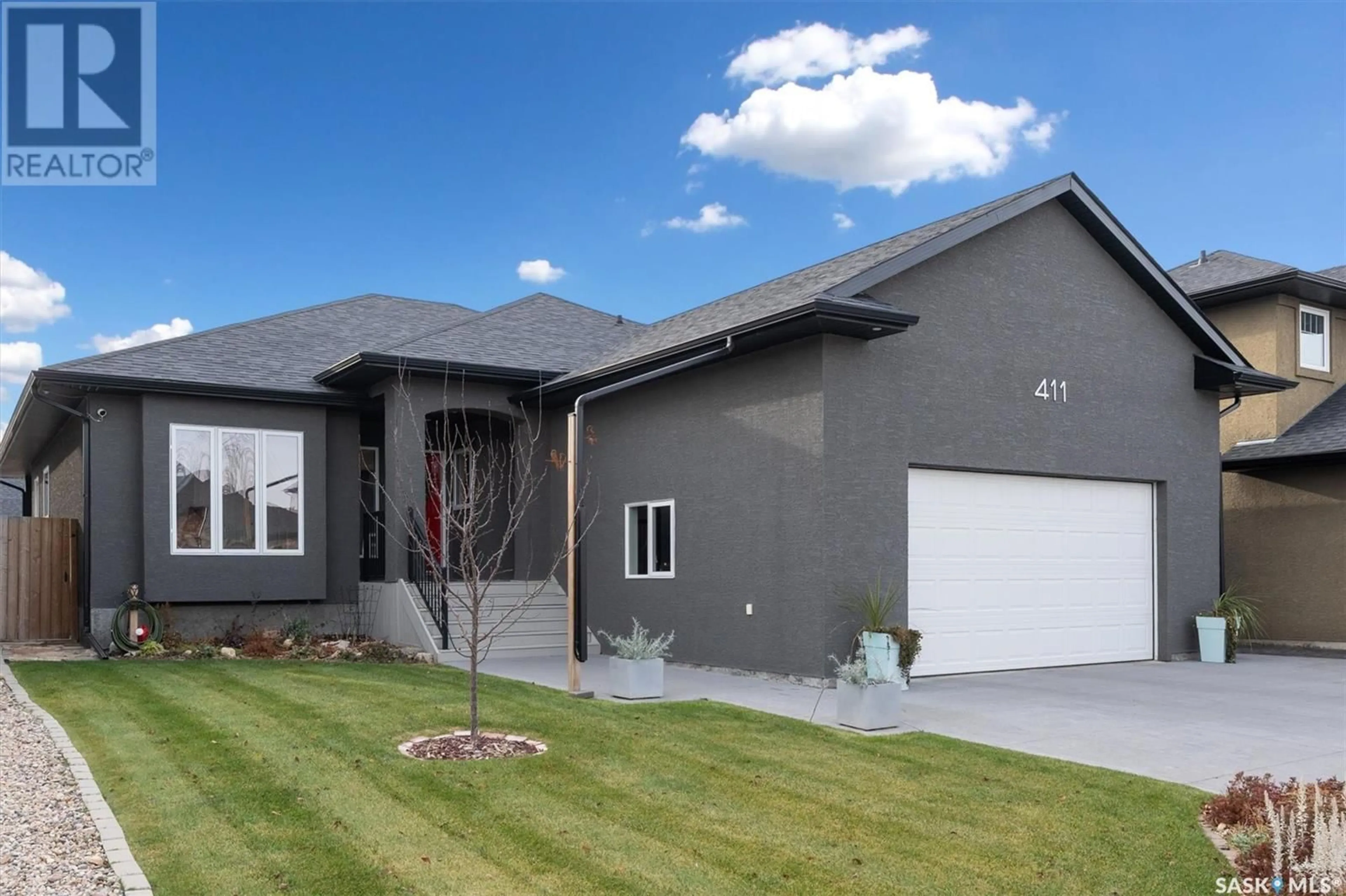 Home with vinyl exterior material, street for 411 Nicklaus DRIVE, Warman Saskatchewan S0K4S1