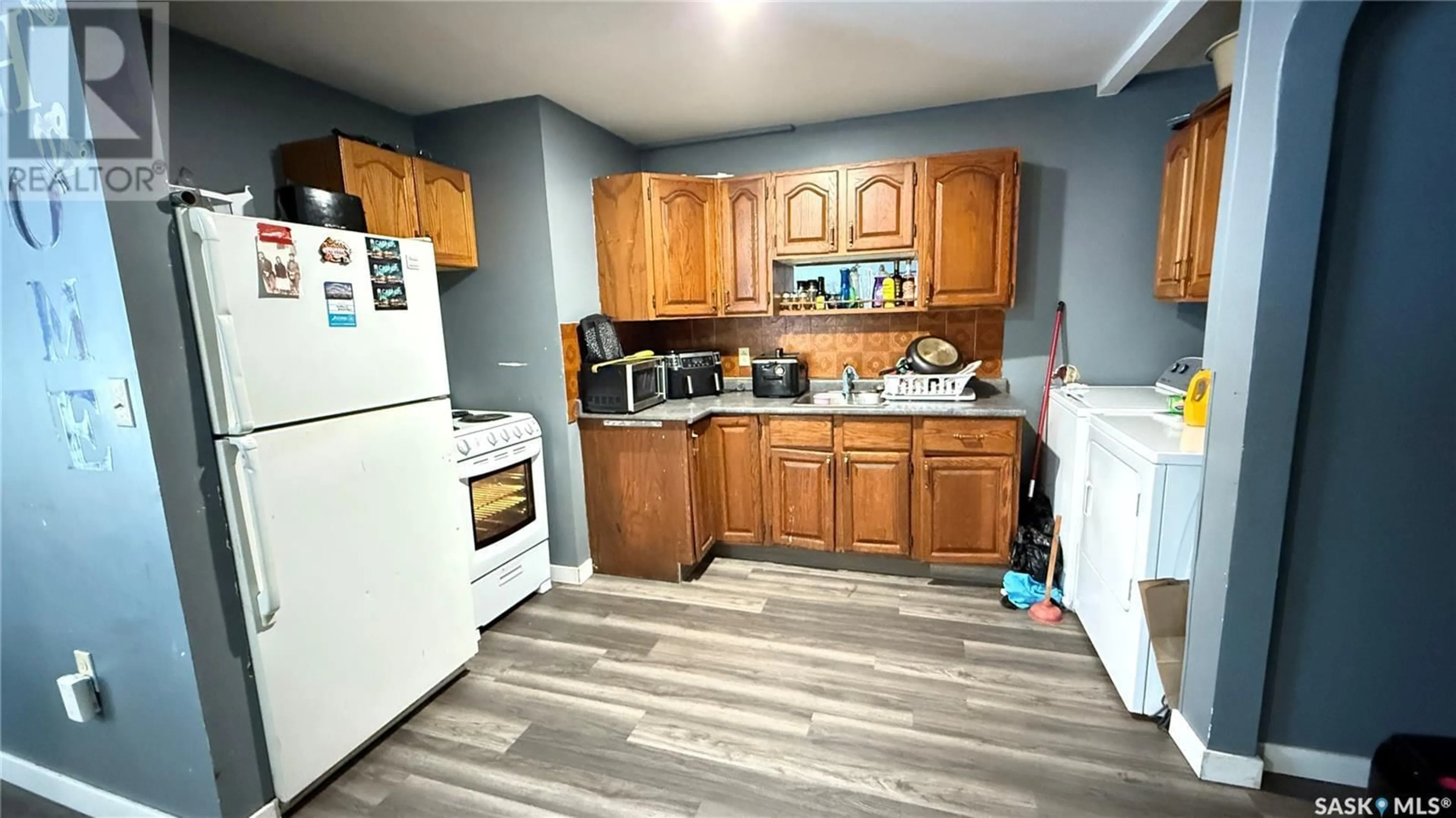 Living room with furniture, wood/laminate floor for A&B - 1402 109TH STREET, North Battleford Saskatchewan S9A2G3