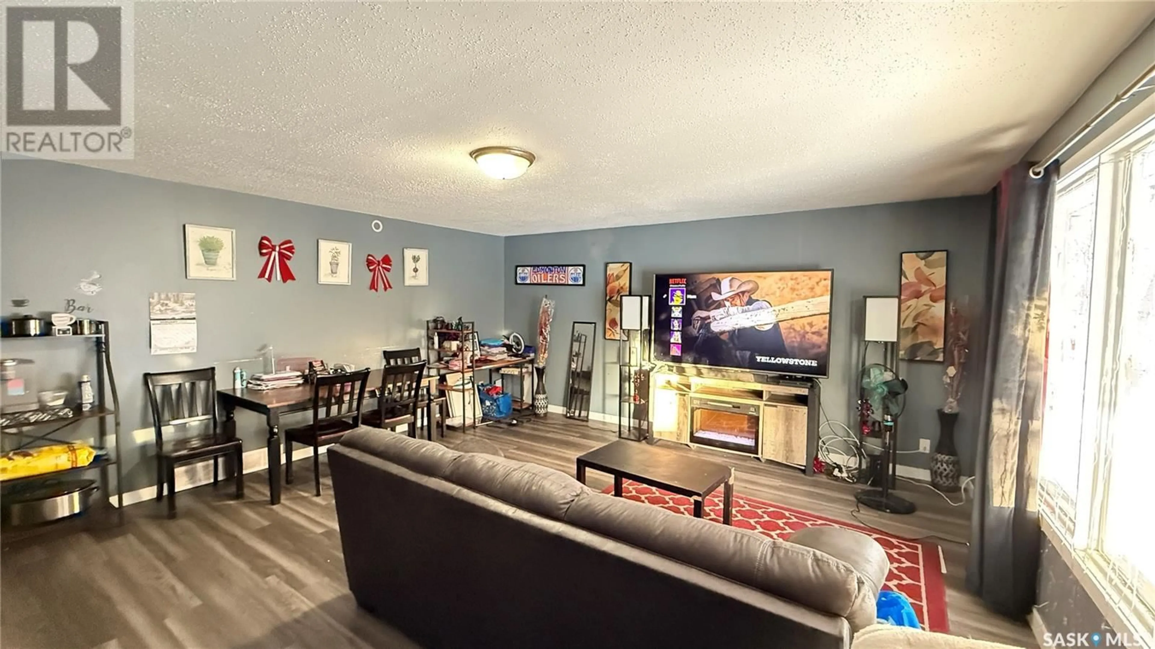 Living room with furniture, wood/laminate floor for A&B 1402 109th STREET, North Battleford Saskatchewan S9A2G3