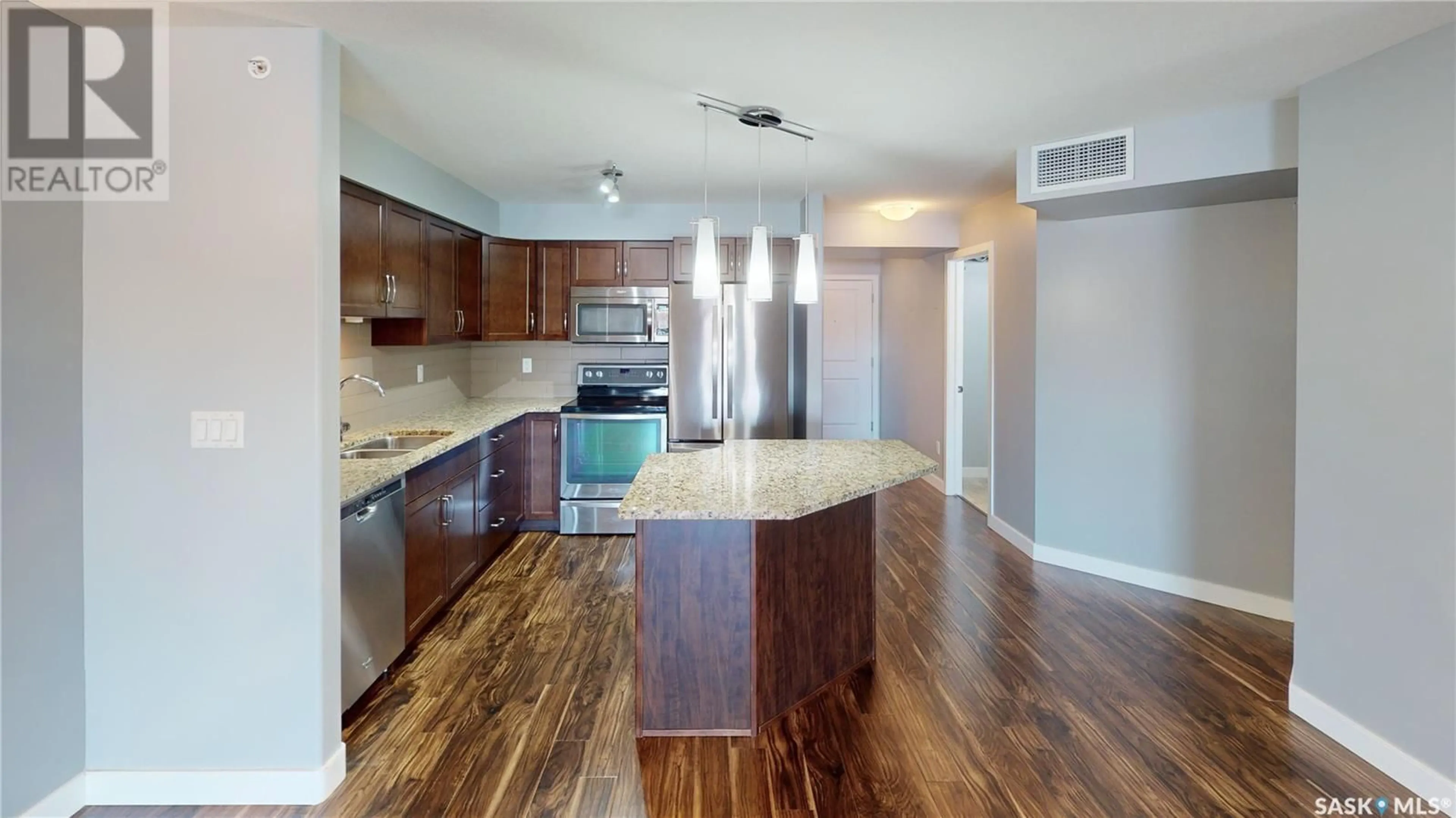 Open concept kitchen, wood/laminate floor for 310 2331 Windsor Park ROAD, Regina Saskatchewan S4V3N3