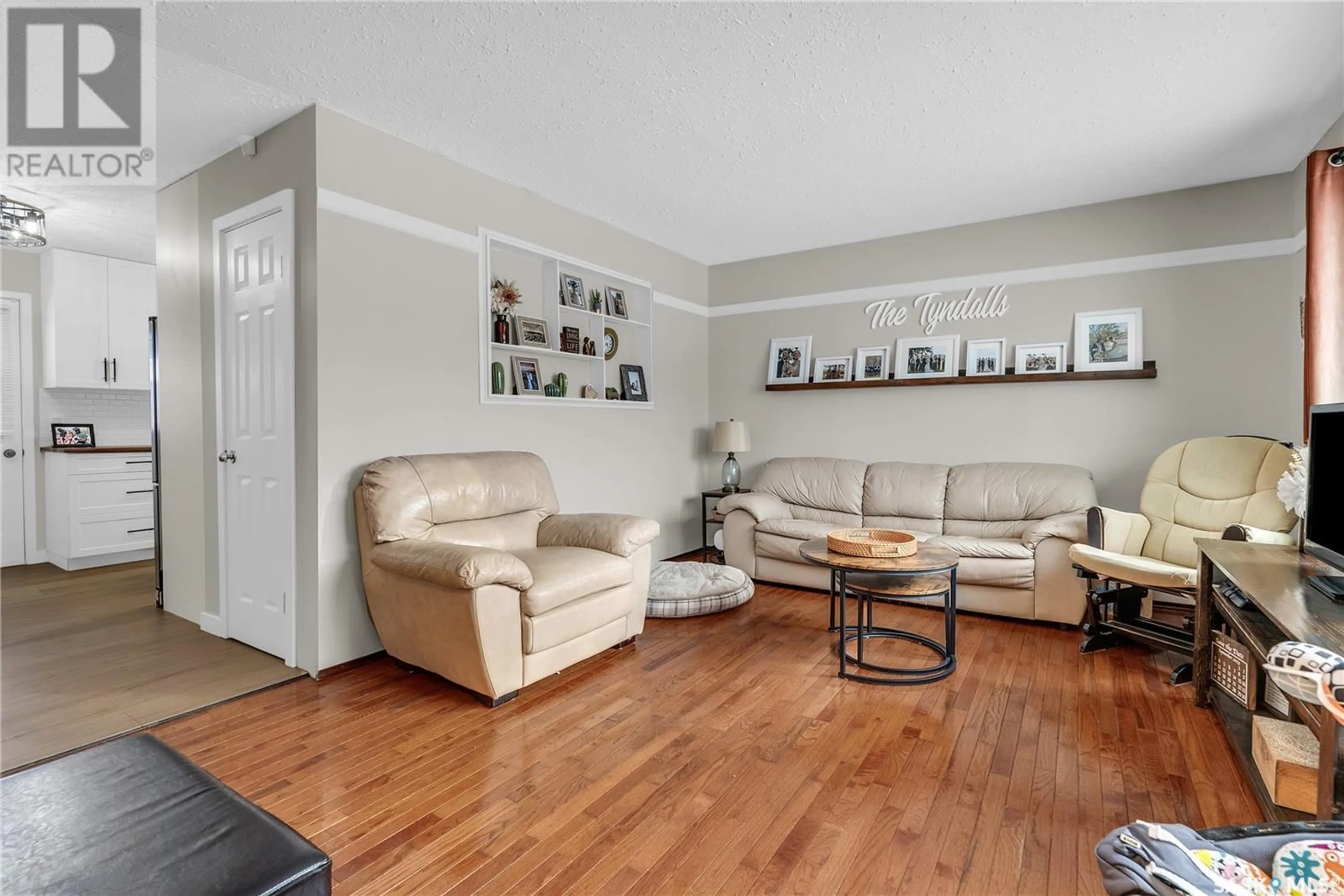 Living room with furniture, wood/laminate floor for 9027 Panton AVENUE, North Battleford Saskatchewan S9A3J8