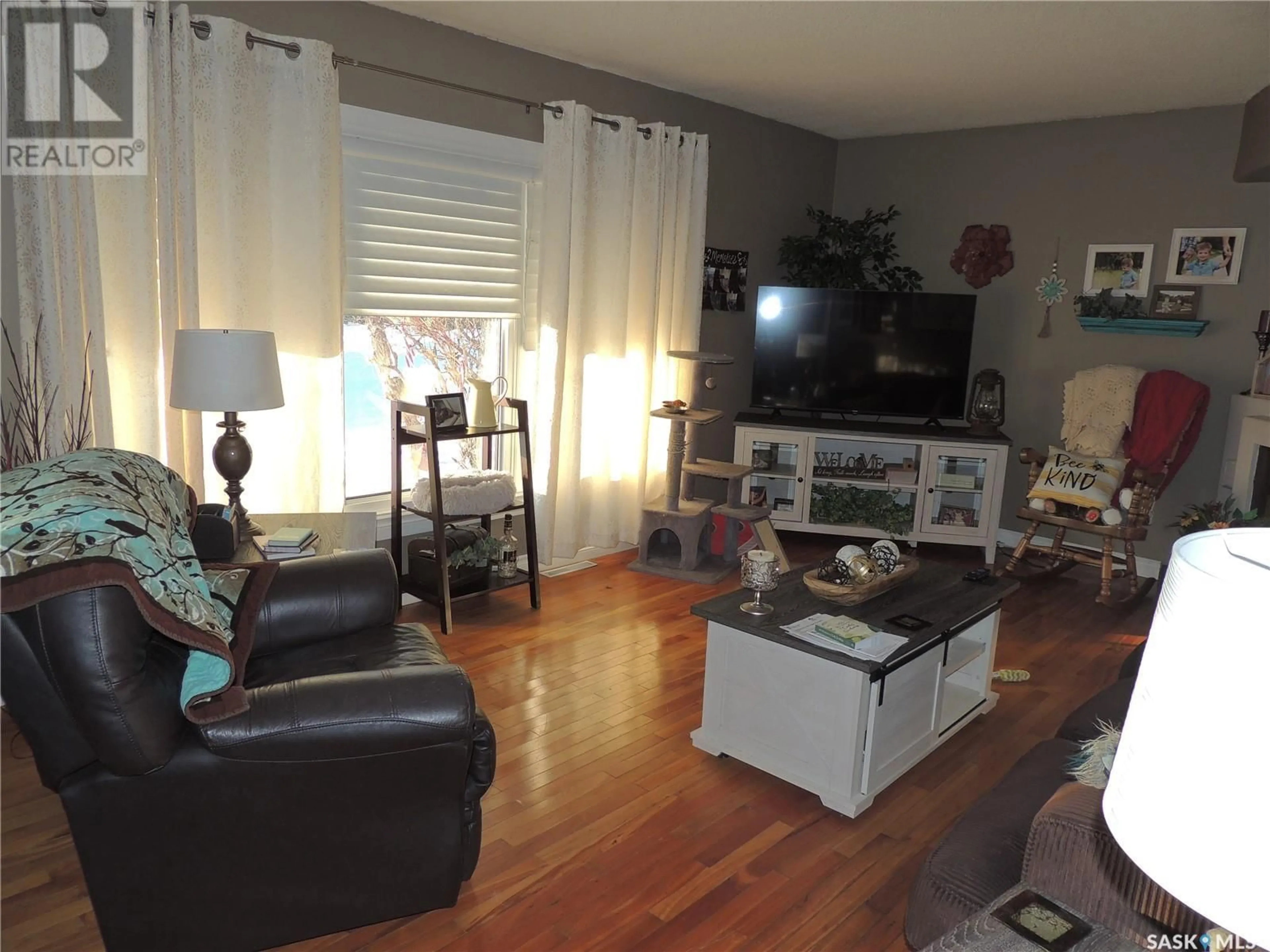 Living room with furniture, wood/laminate floor for 1902 DYER ROAD, Estevan Saskatchewan S4A1Z5