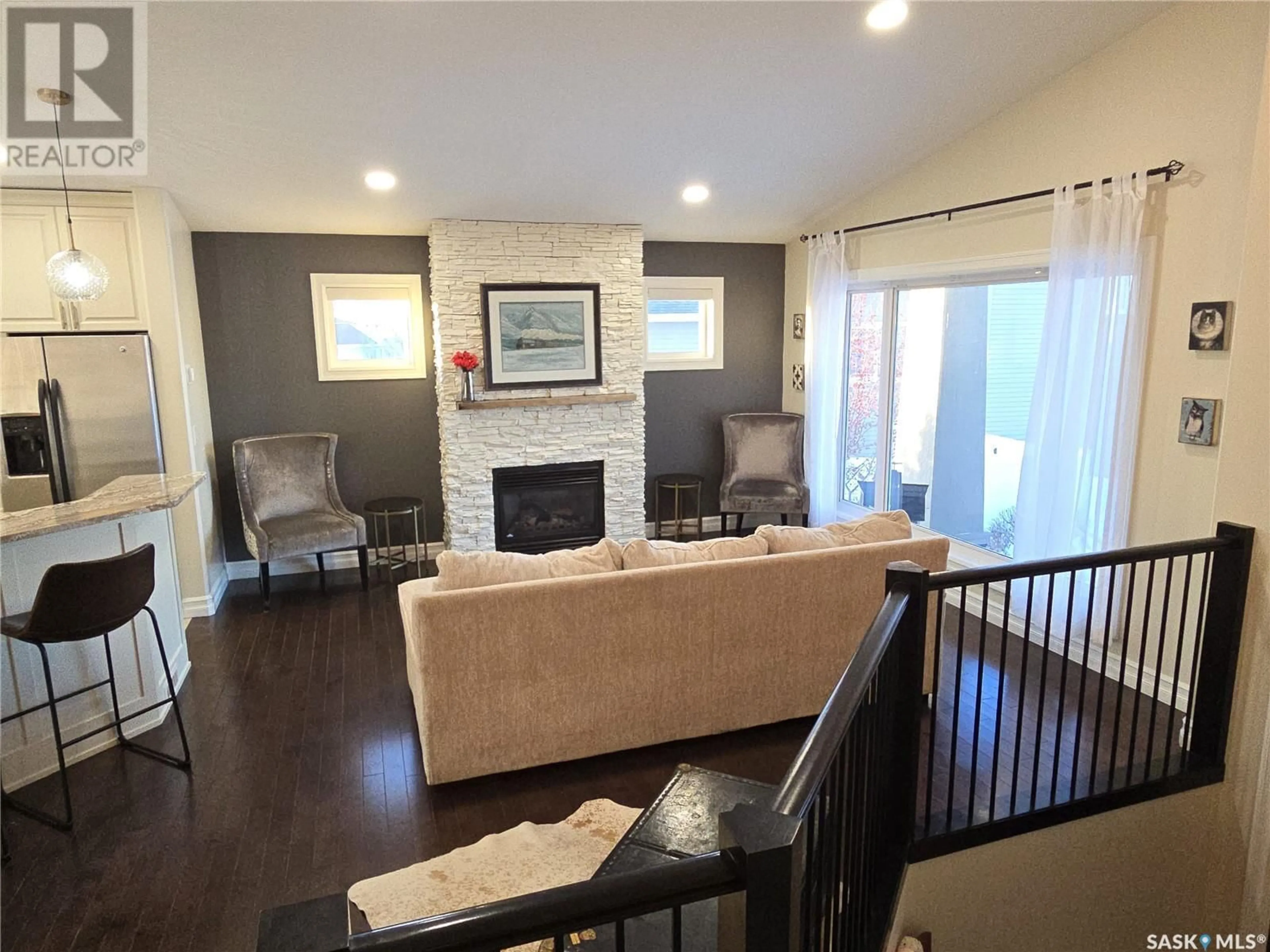 Living room with furniture, wood/laminate floor for 6 Cedar PLACE, Outlook Saskatchewan S0L2N0