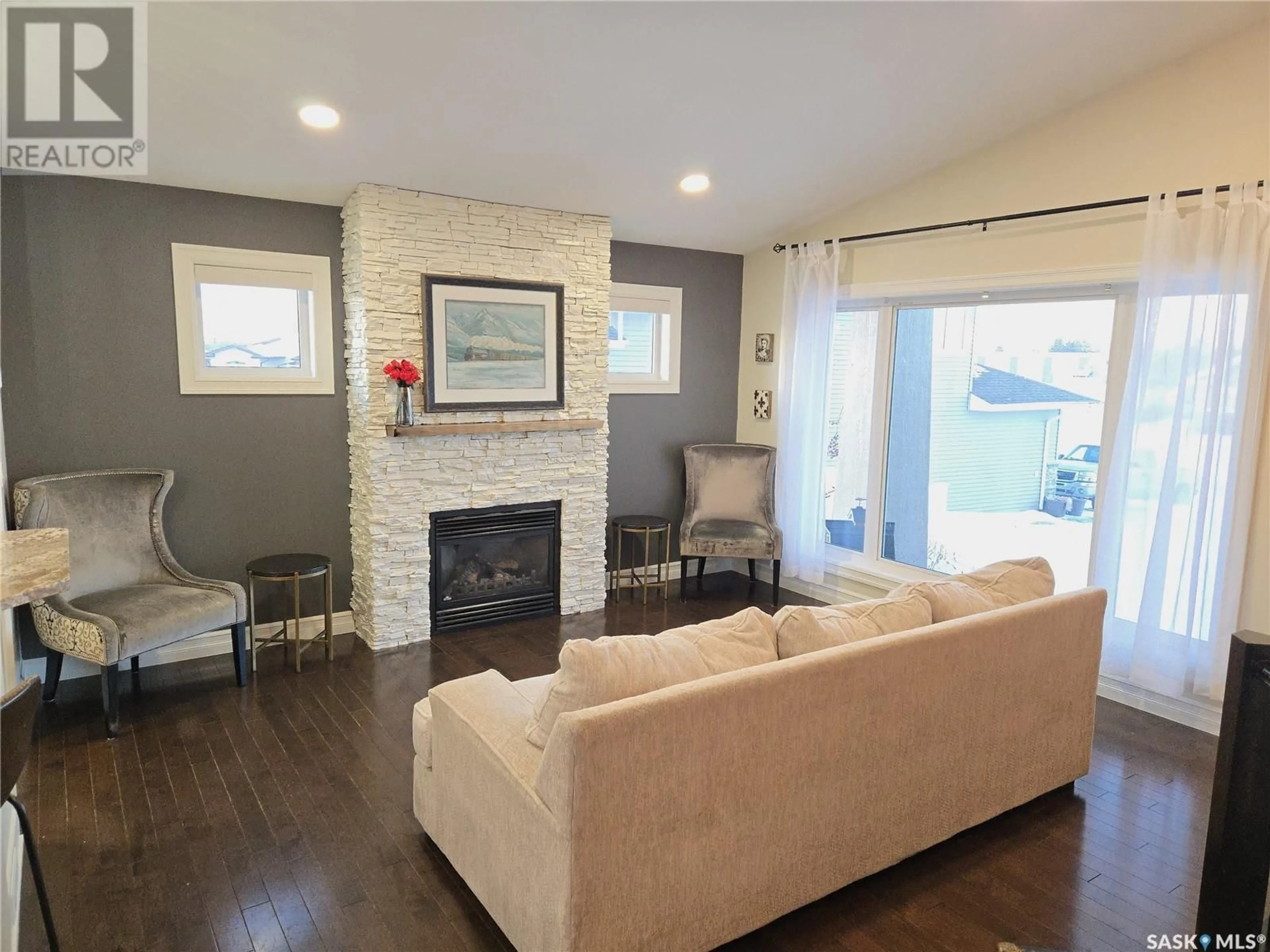 Living room with furniture, wood/laminate floor for 6 Cedar PLACE, Outlook Saskatchewan S0L2N0