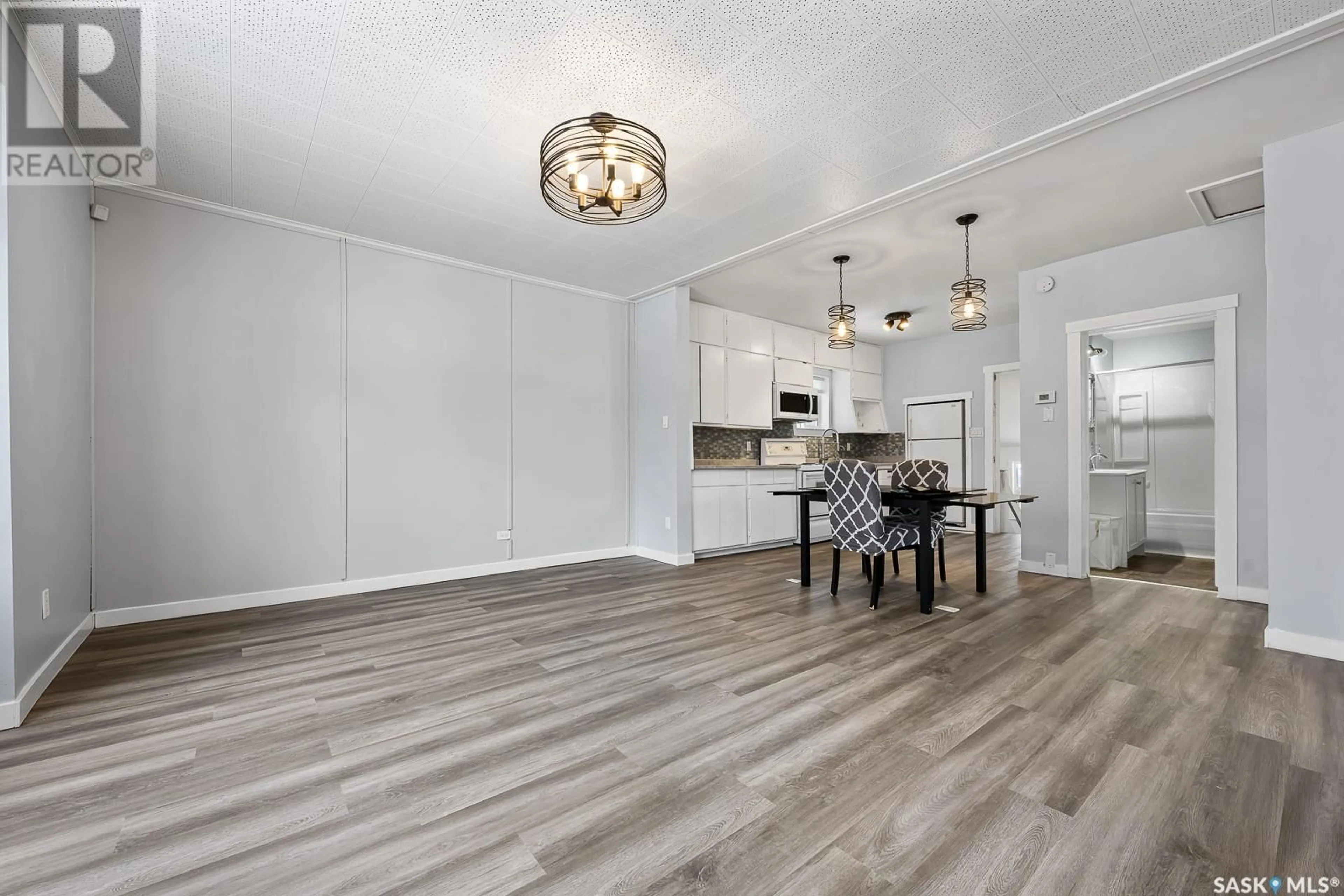 Open concept kitchen, wood/laminate floor for 955 ELLIOTT STREET, Regina Saskatchewan S4N3E5