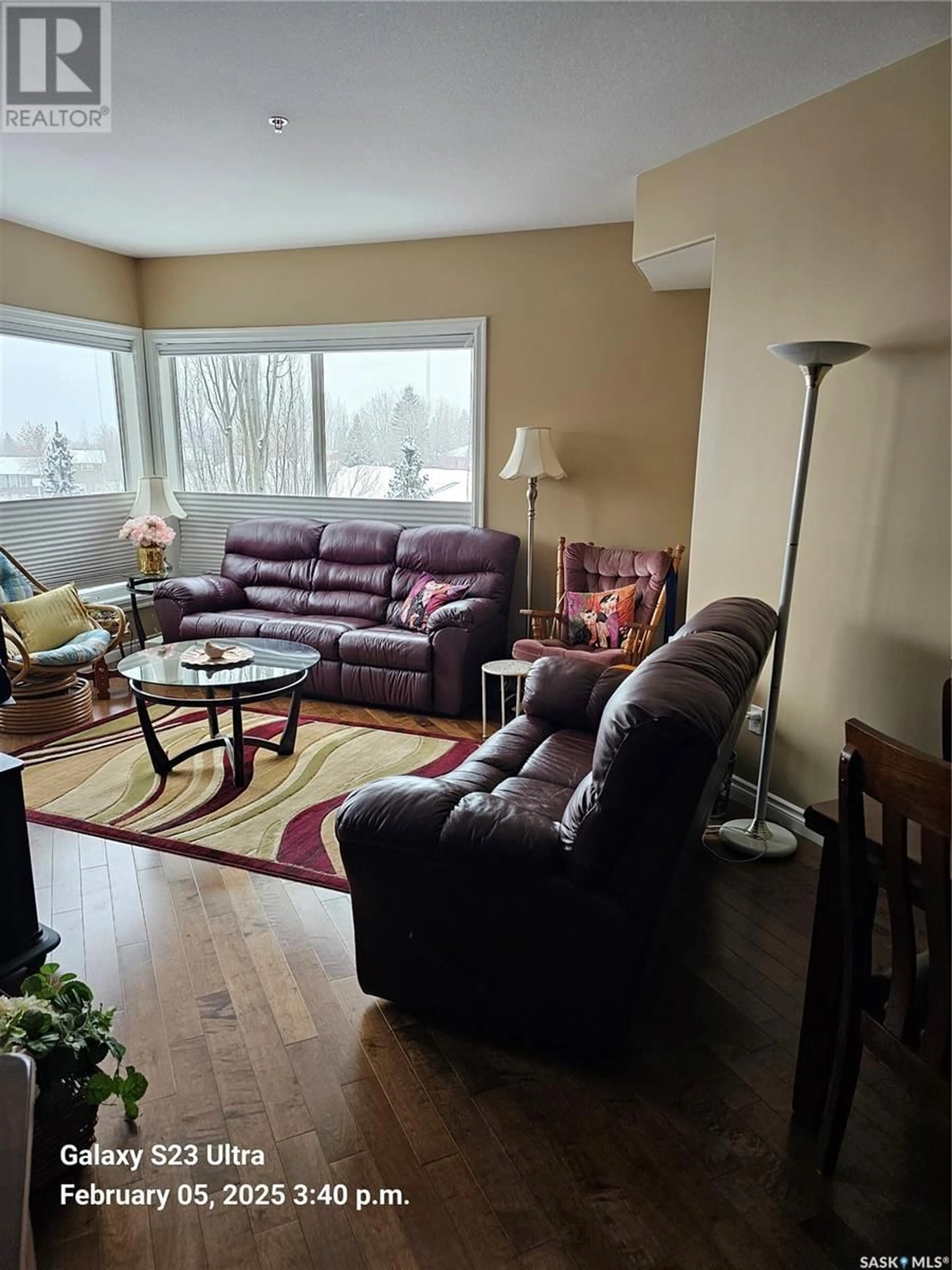 Living room with furniture, wood/laminate floor for 205 227 Pinehouse DRIVE, Saskatoon Saskatchewan S7K6N9