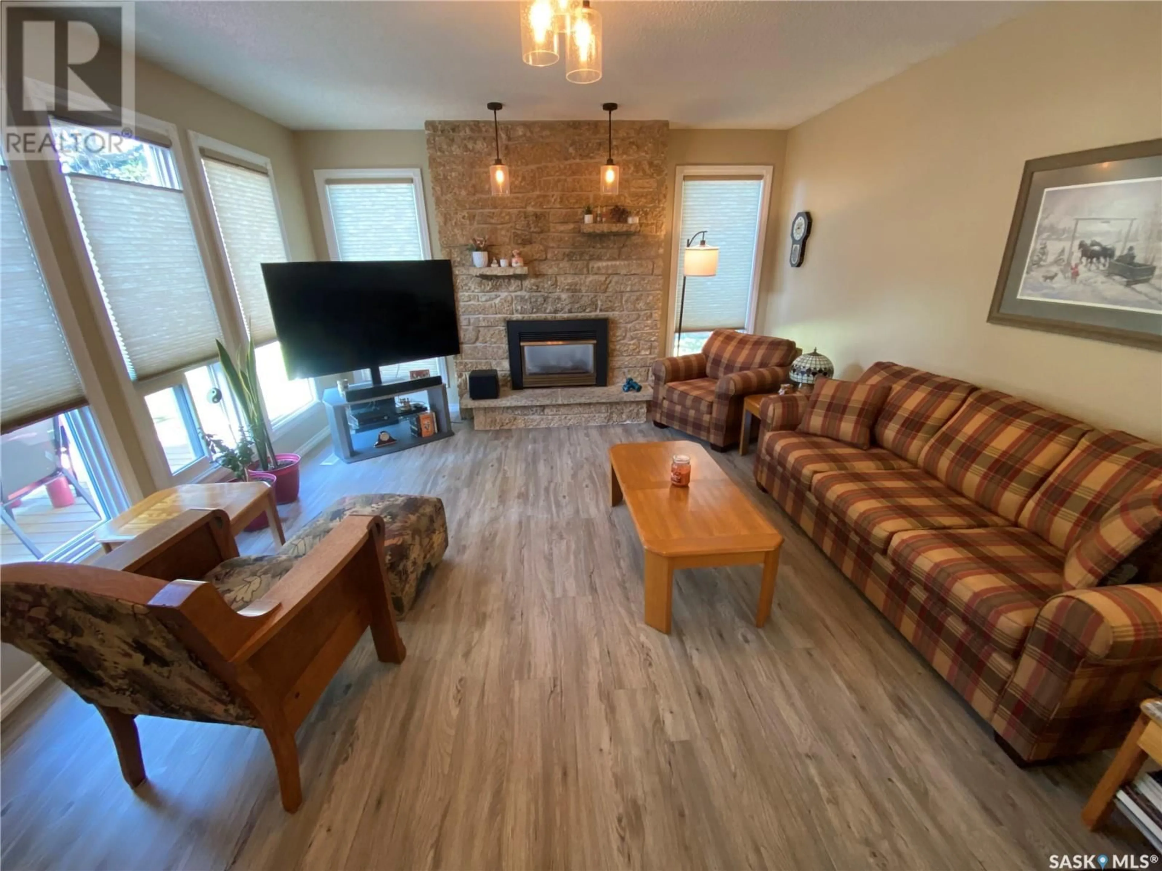 Living room with furniture, wood/laminate floor for 153 Logan CRESCENT W, Yorkton Saskatchewan S3N0W6