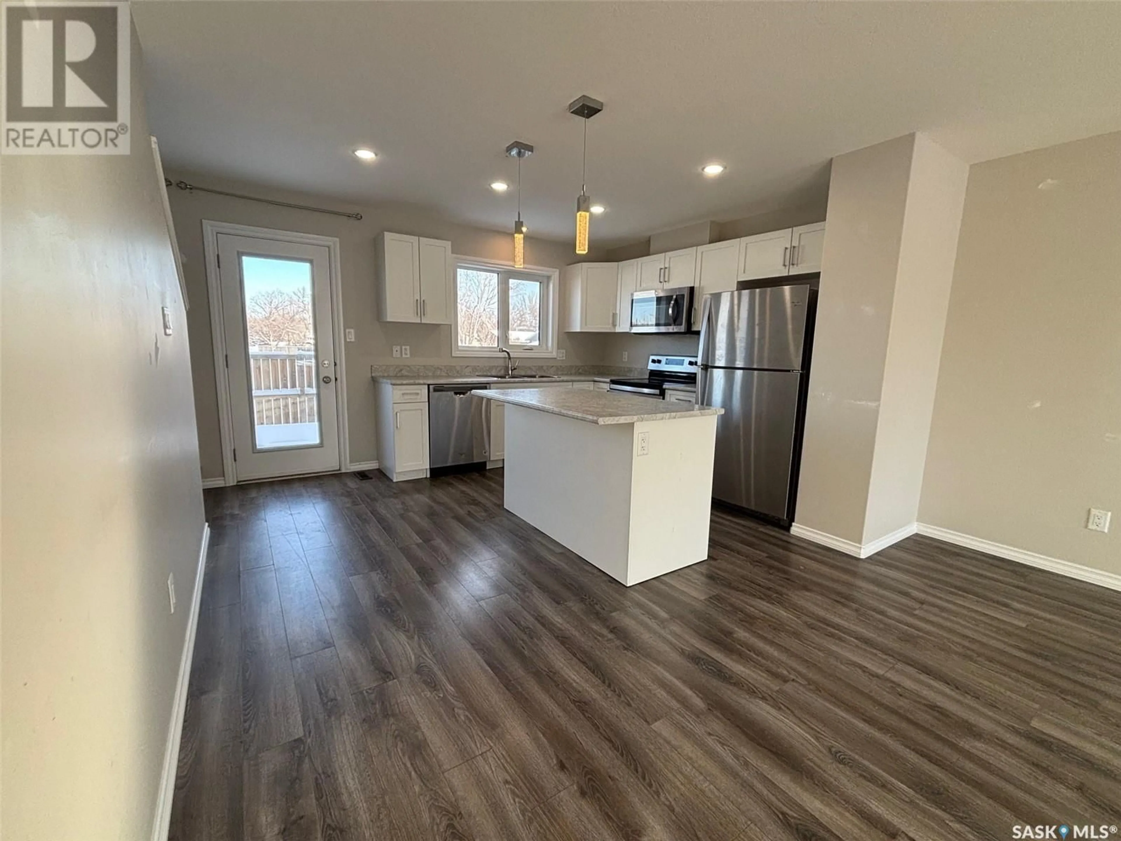 Open concept kitchen, wood/laminate floor for 114 1920 7th AVENUE E, Regina Saskatchewan S4N4N8