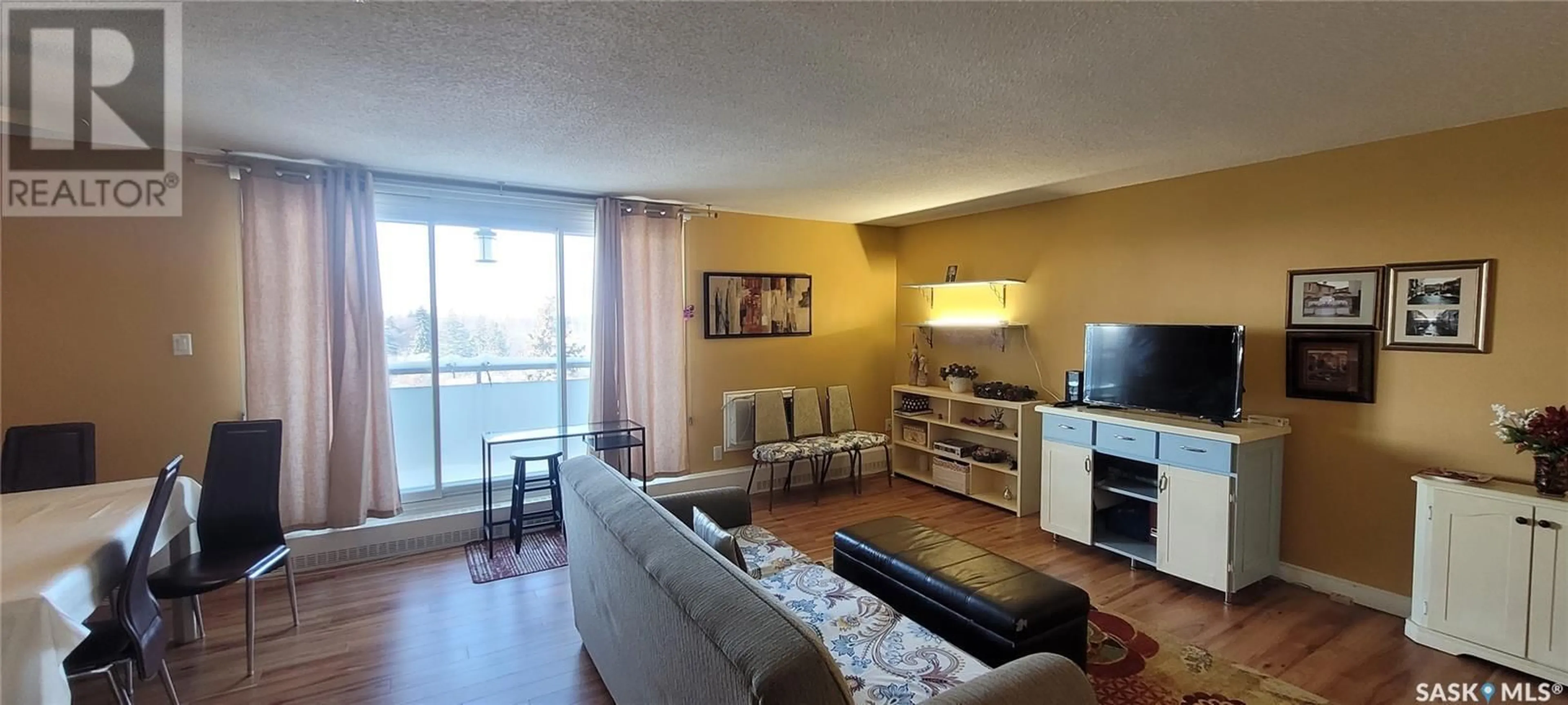 Living room with furniture, wood/laminate floor for 608 4615 Rae STREET, Regina Saskatchewan S4S3B2